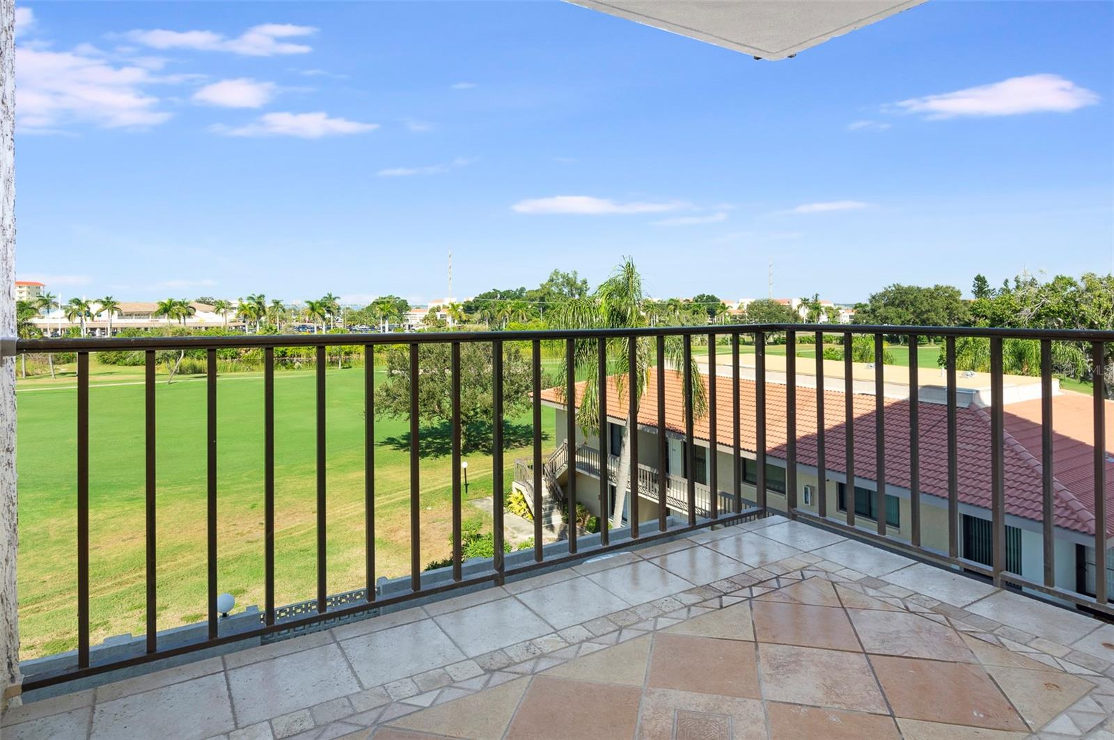 Watch golfers swing by and peaks of Boca Ciega Bay inthe distance