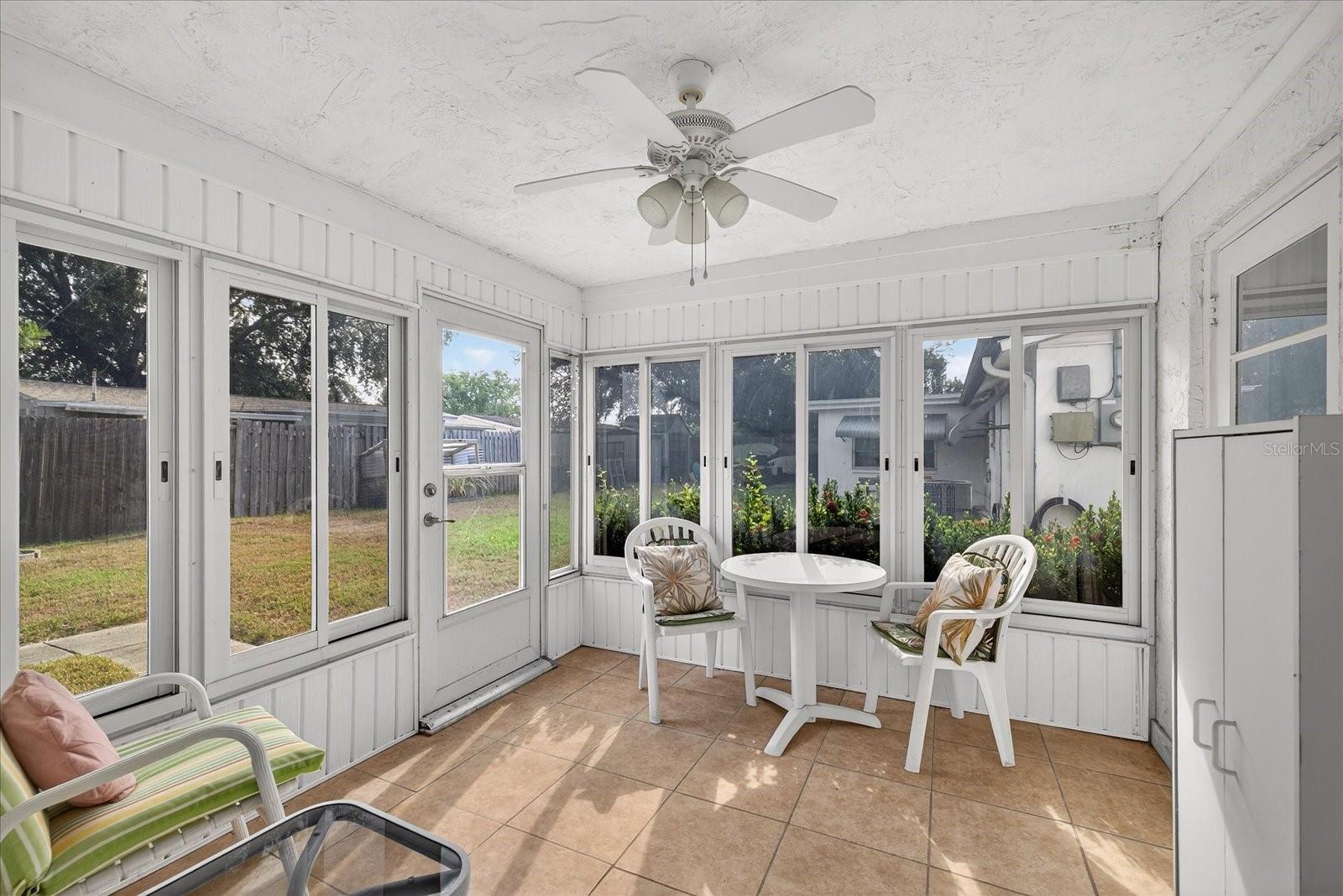 Florida room with door to back yard & garage