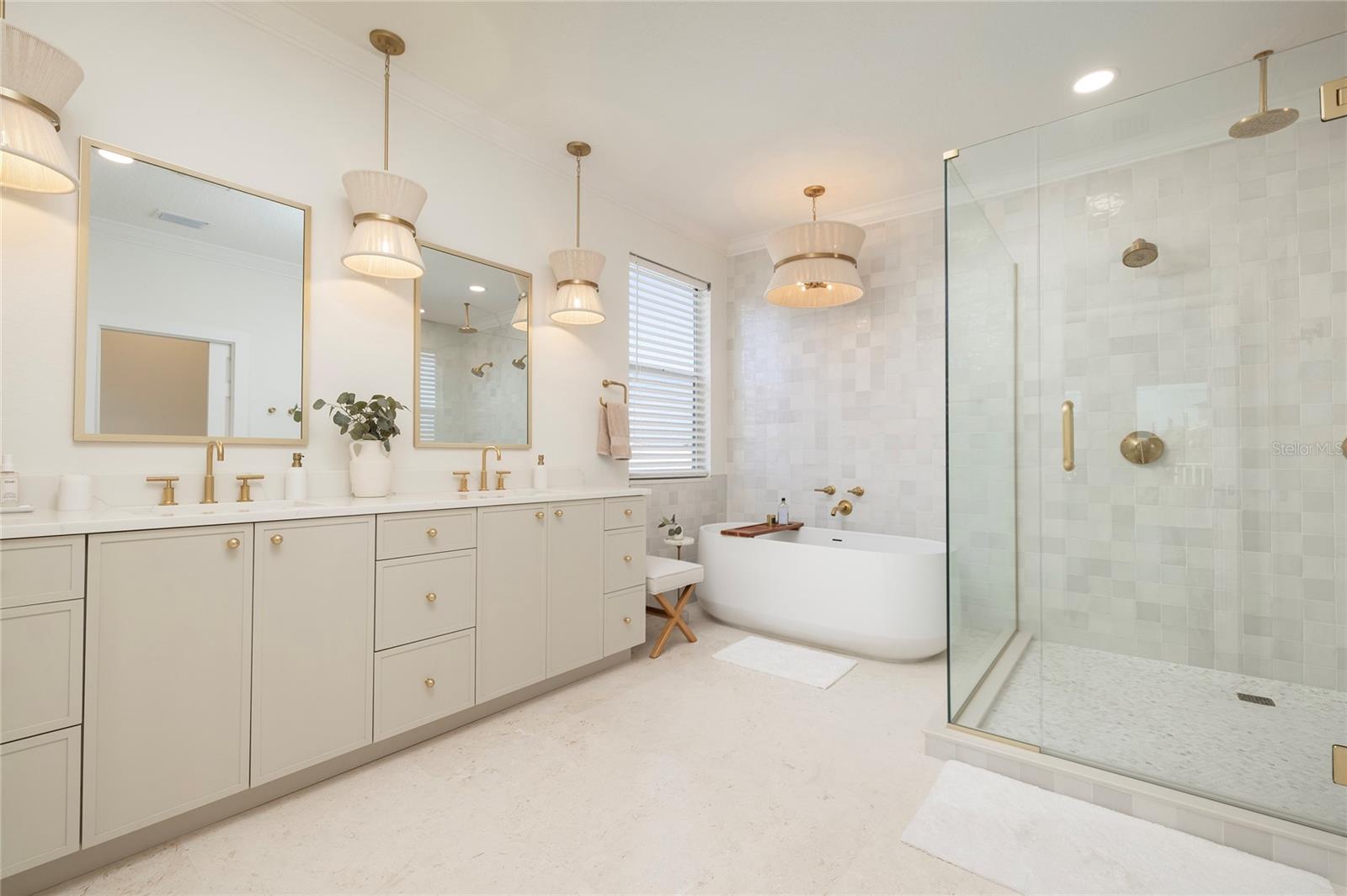 Primary Bathroom with dual faucets, limestone floors and custom cabinetry