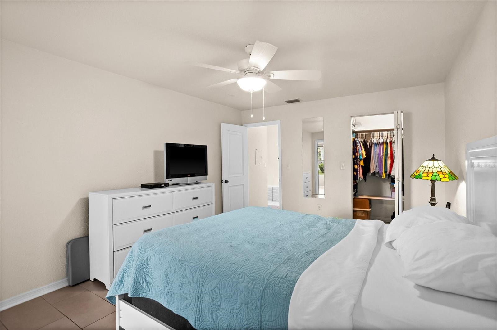 primary bedroom with ceiling fan