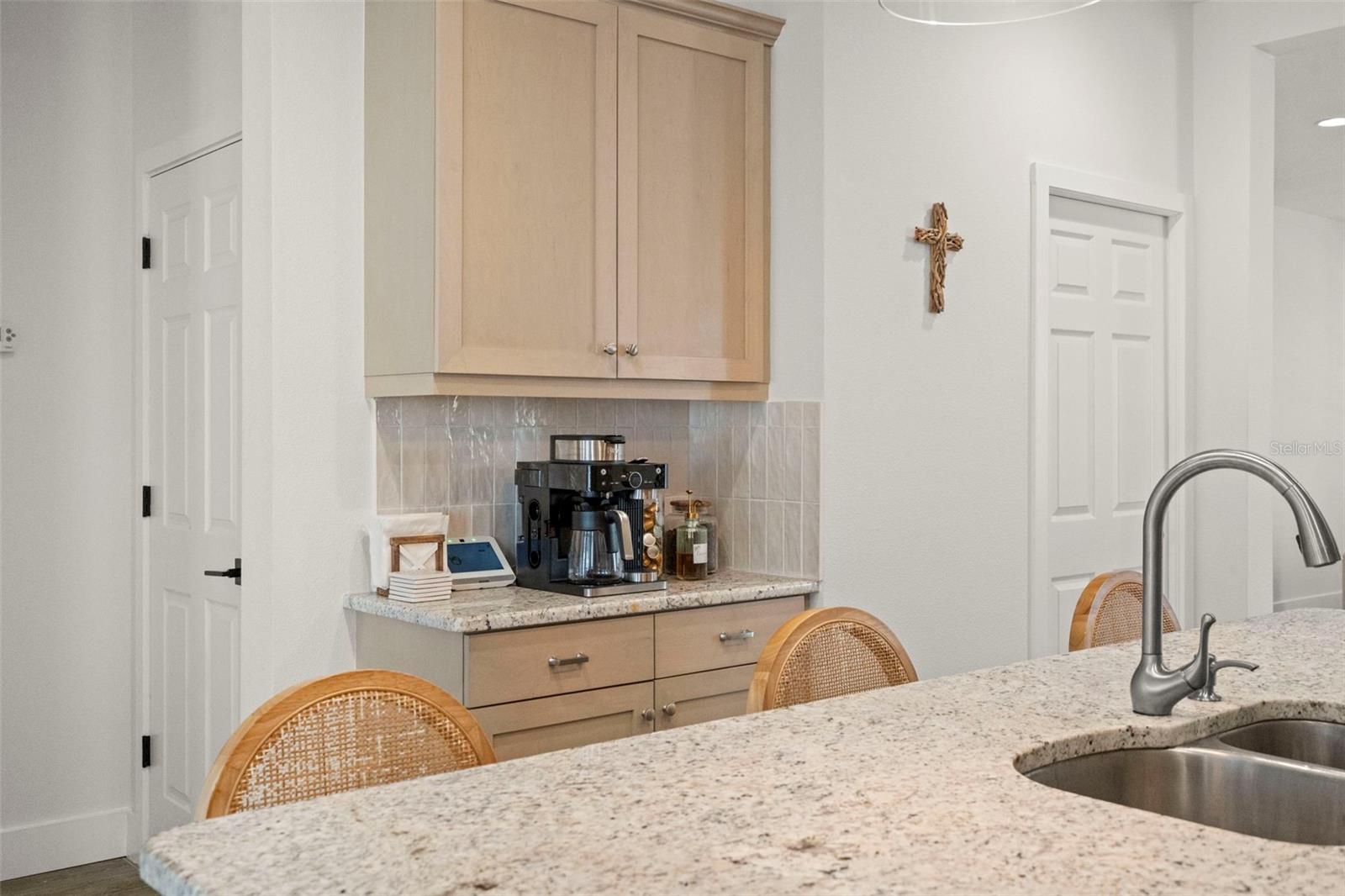 Large pantry in door behind coffee bar