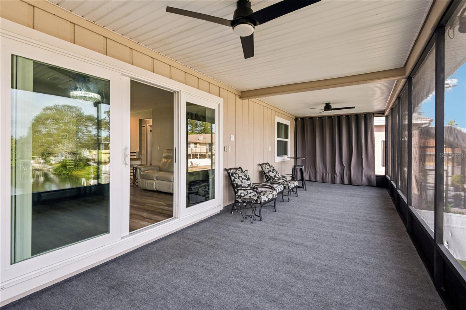 Expansive screened-in porch with new ceiling fans