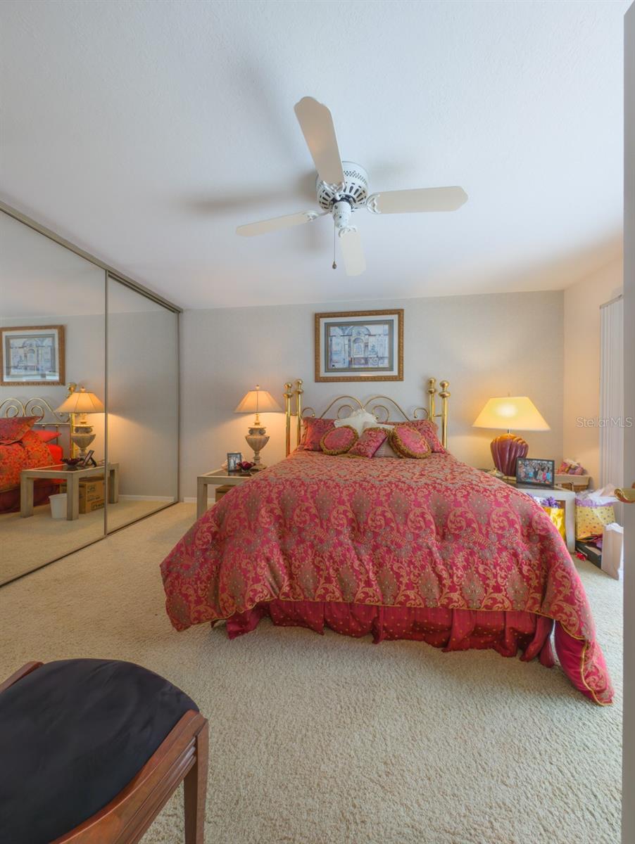 2nd bedroom with sliding doors that overlook pool
