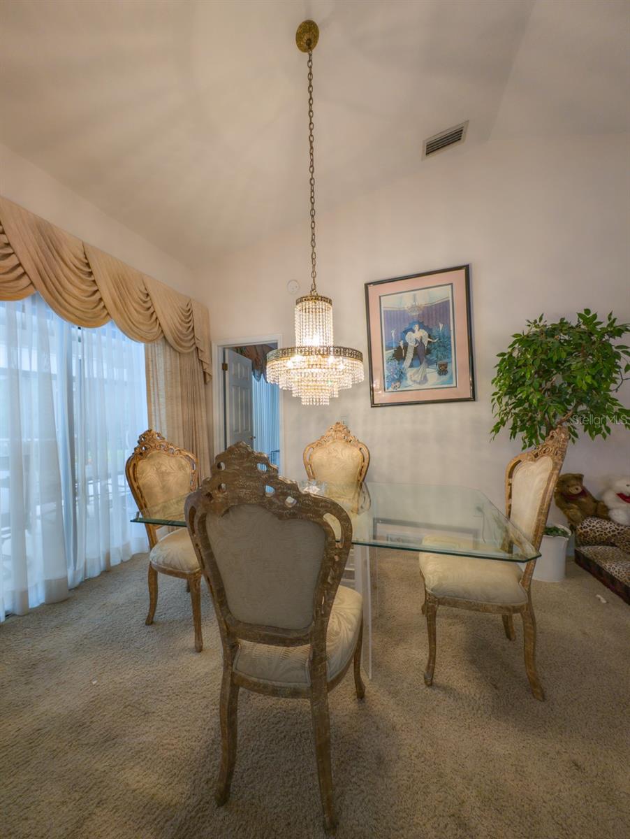 formal dining room overlooks patio and pool