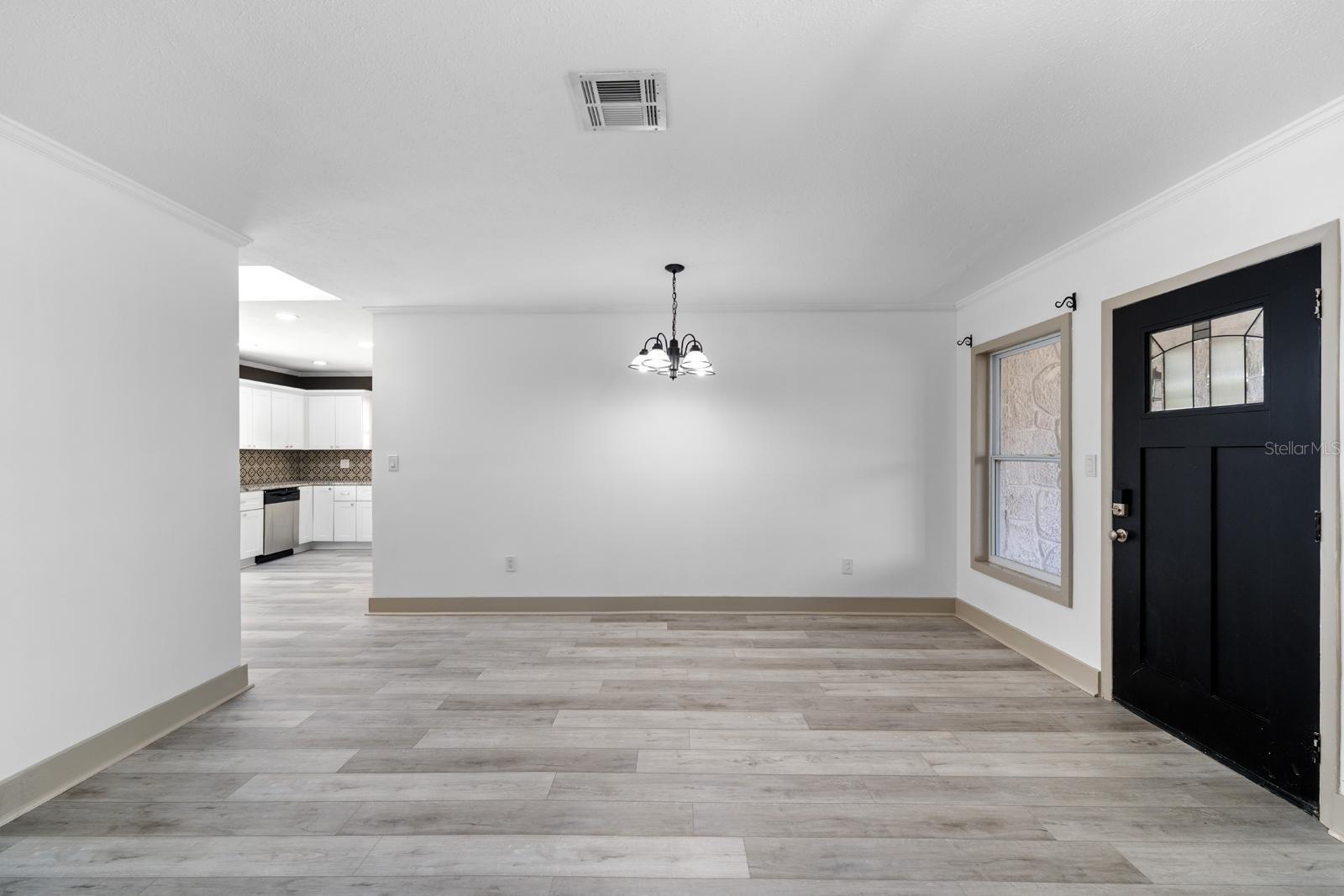 Spacious living, dining combo overlooking front porch and kitchen