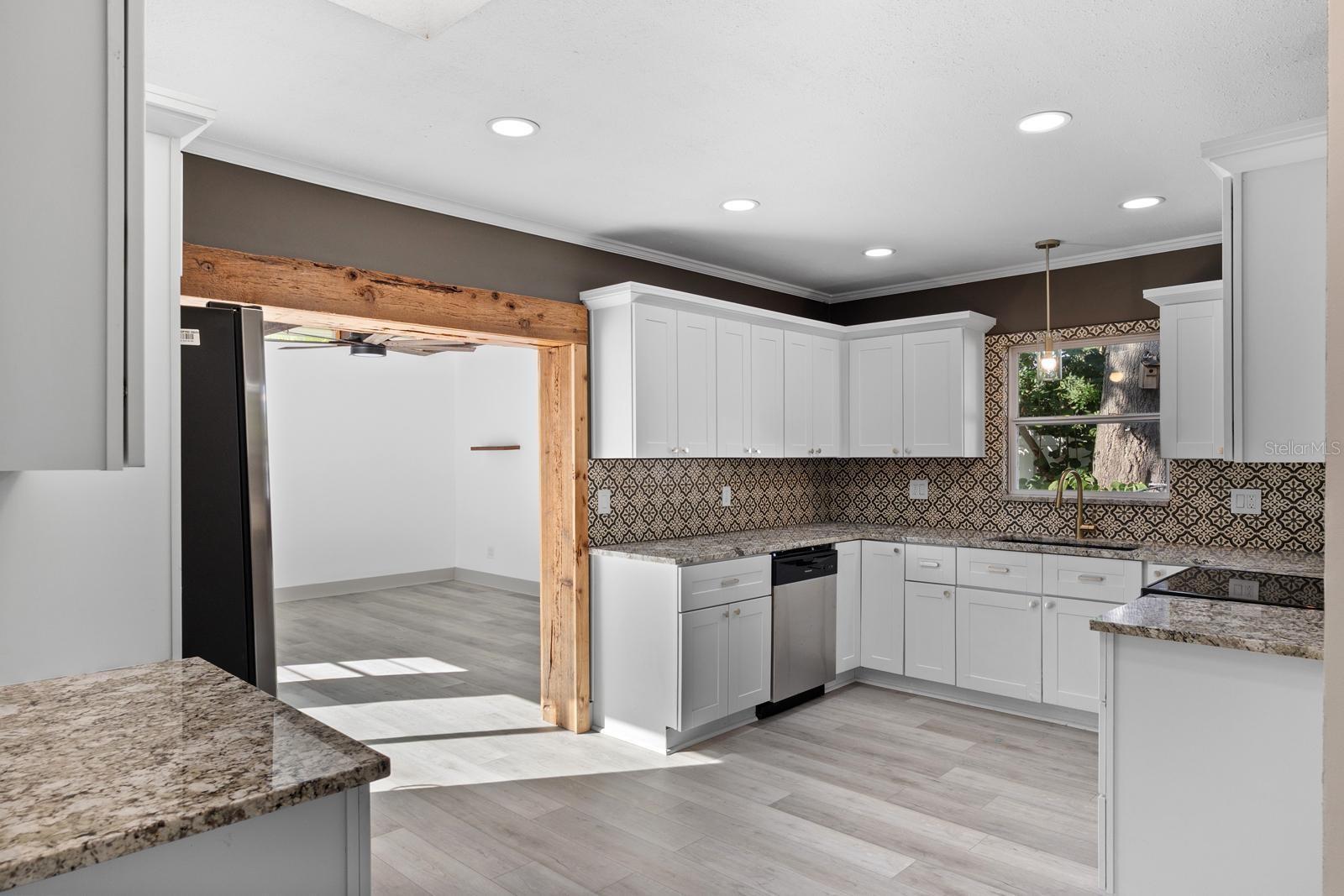 Kitchen with granite countertops and tile backsplash