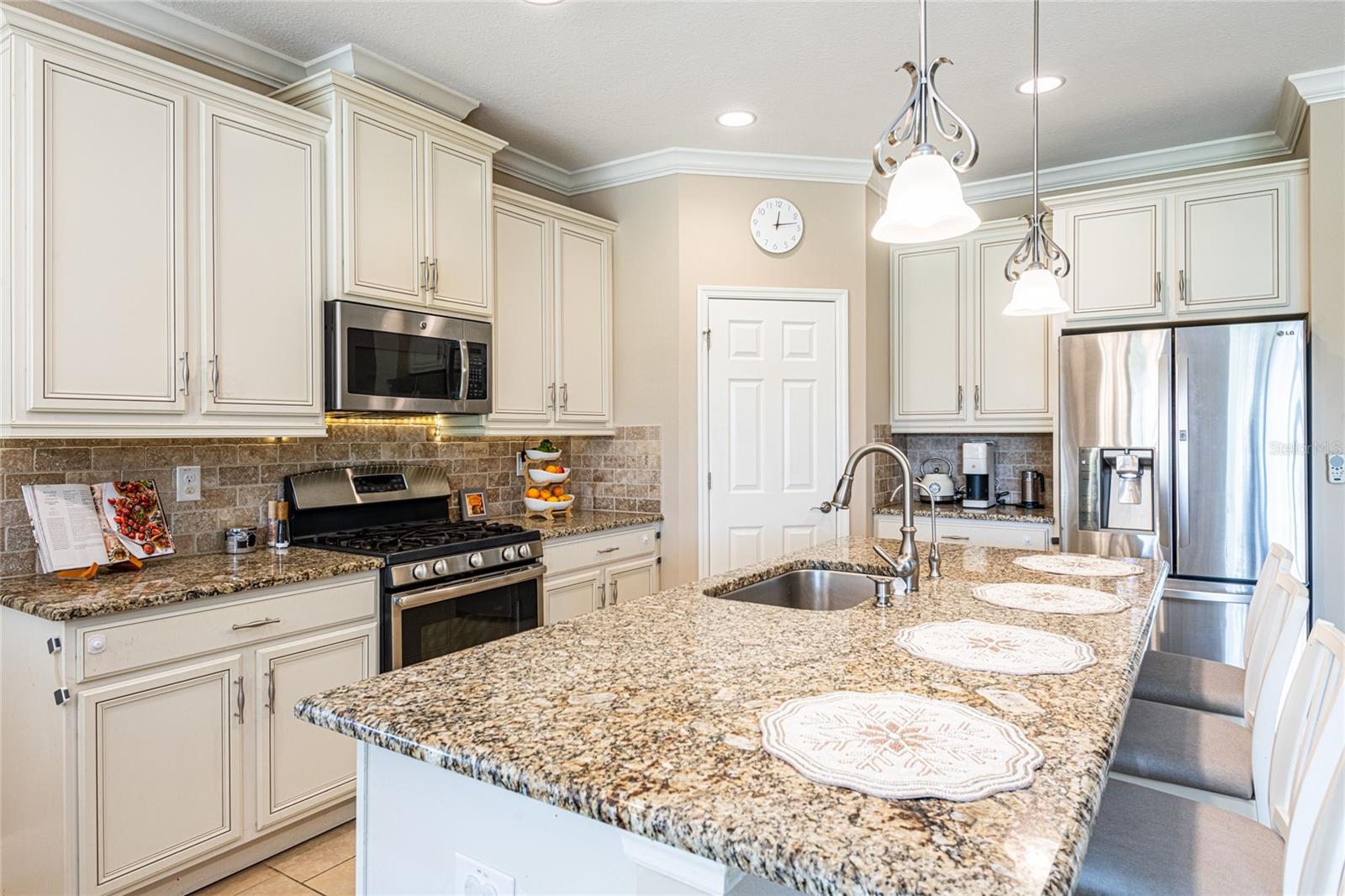 Granite countertops, all stainless steel appliances, pantry, and beautiful cabinetry.