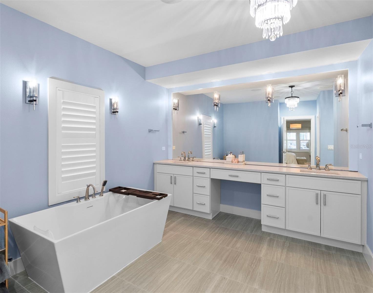 A spacious bathroom with soaking tub, dual sink vanity