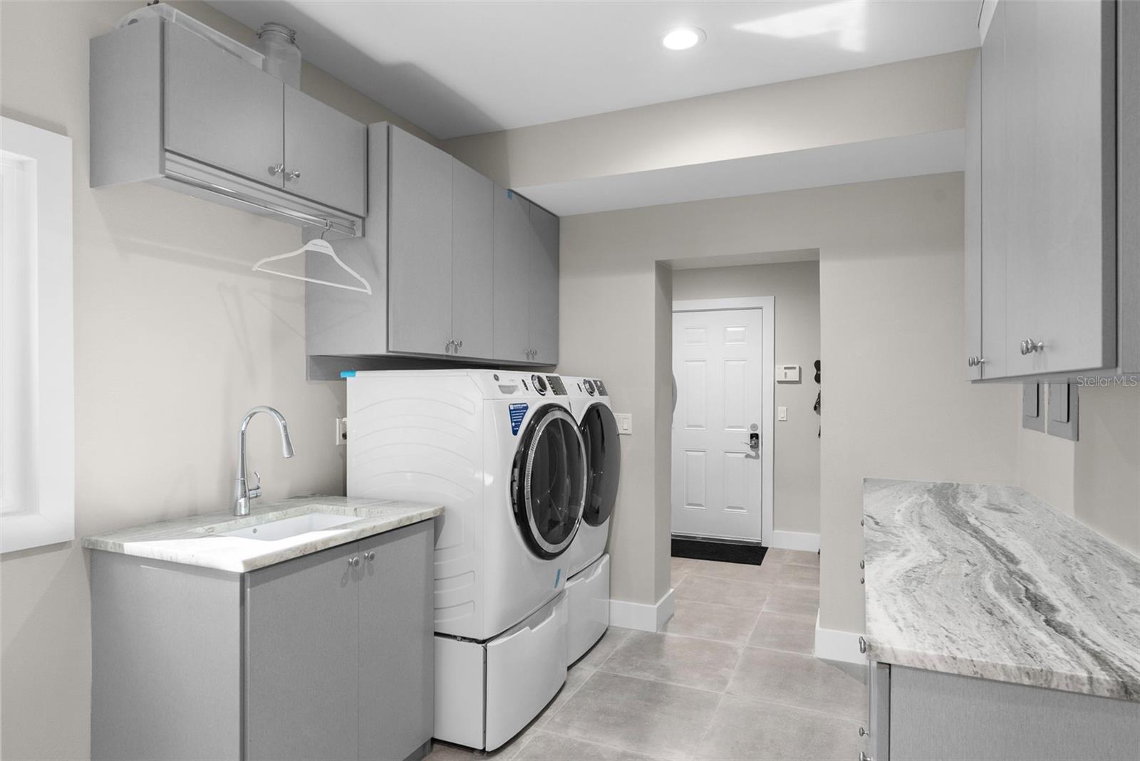 The laundry is off the mudroom by the garage and back staircase