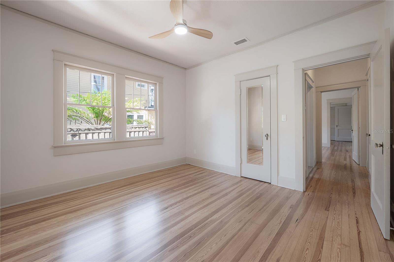 Large bedroom featuring freshly refinished wood floors