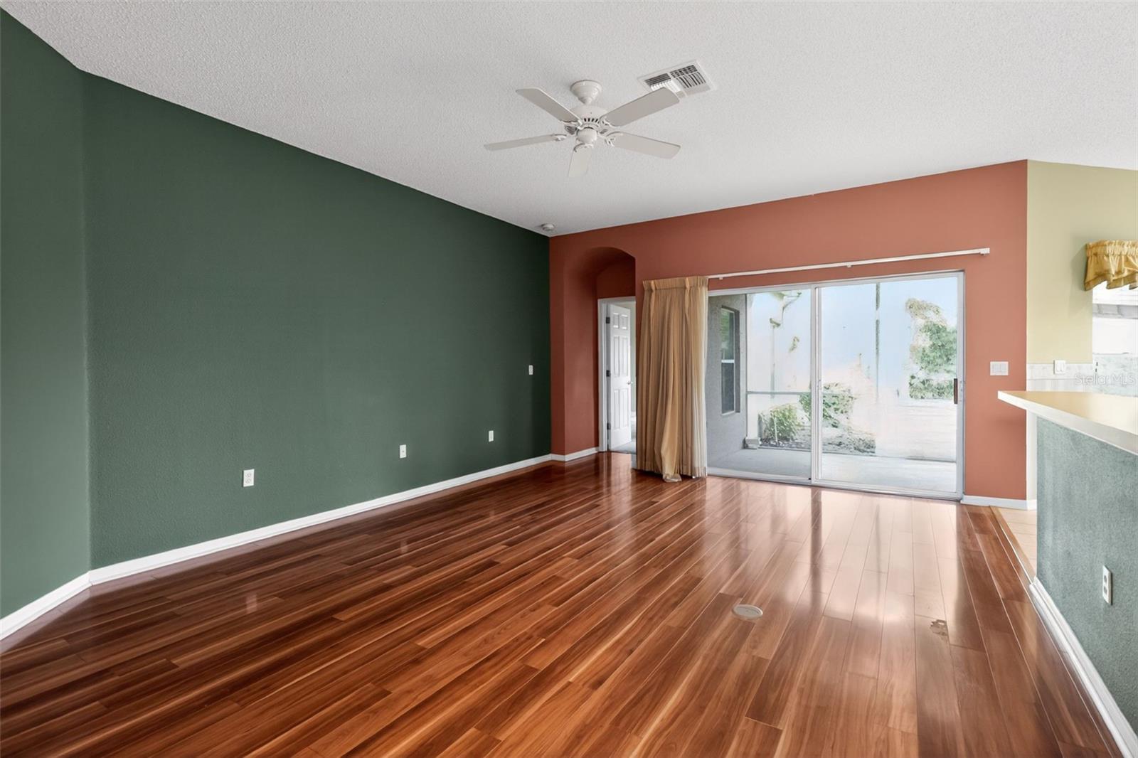 Large, open concept living area with laminate flooring and ample natural light