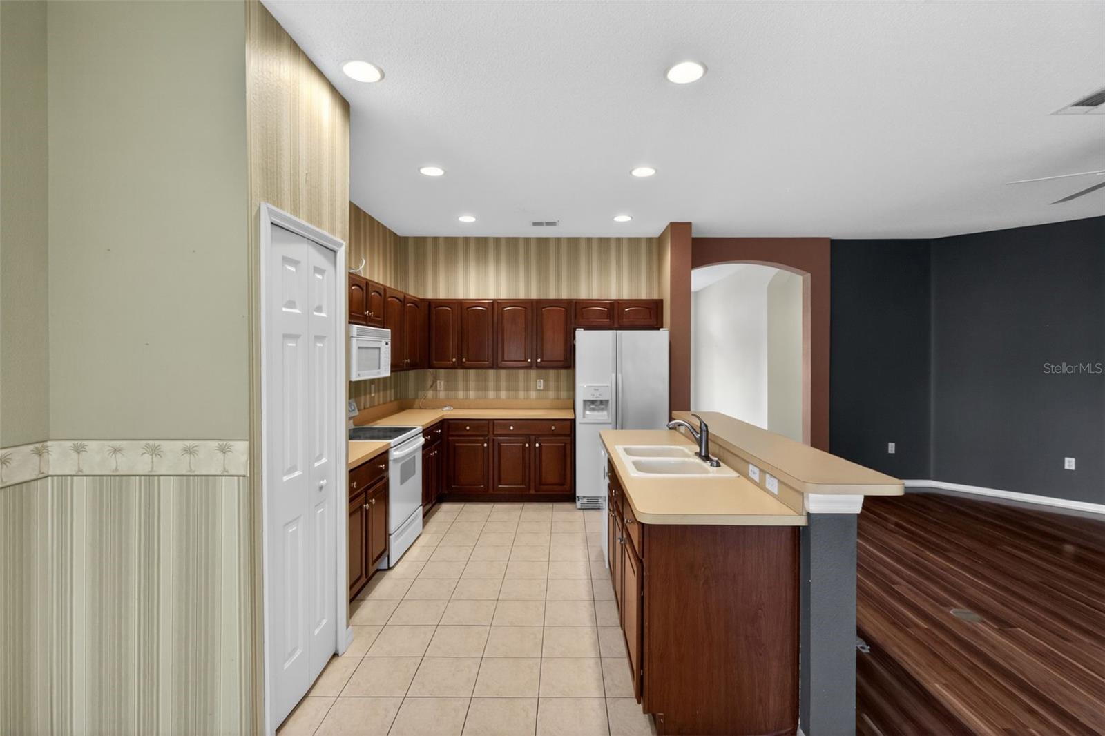 Large island with ample cabinet space and pantry