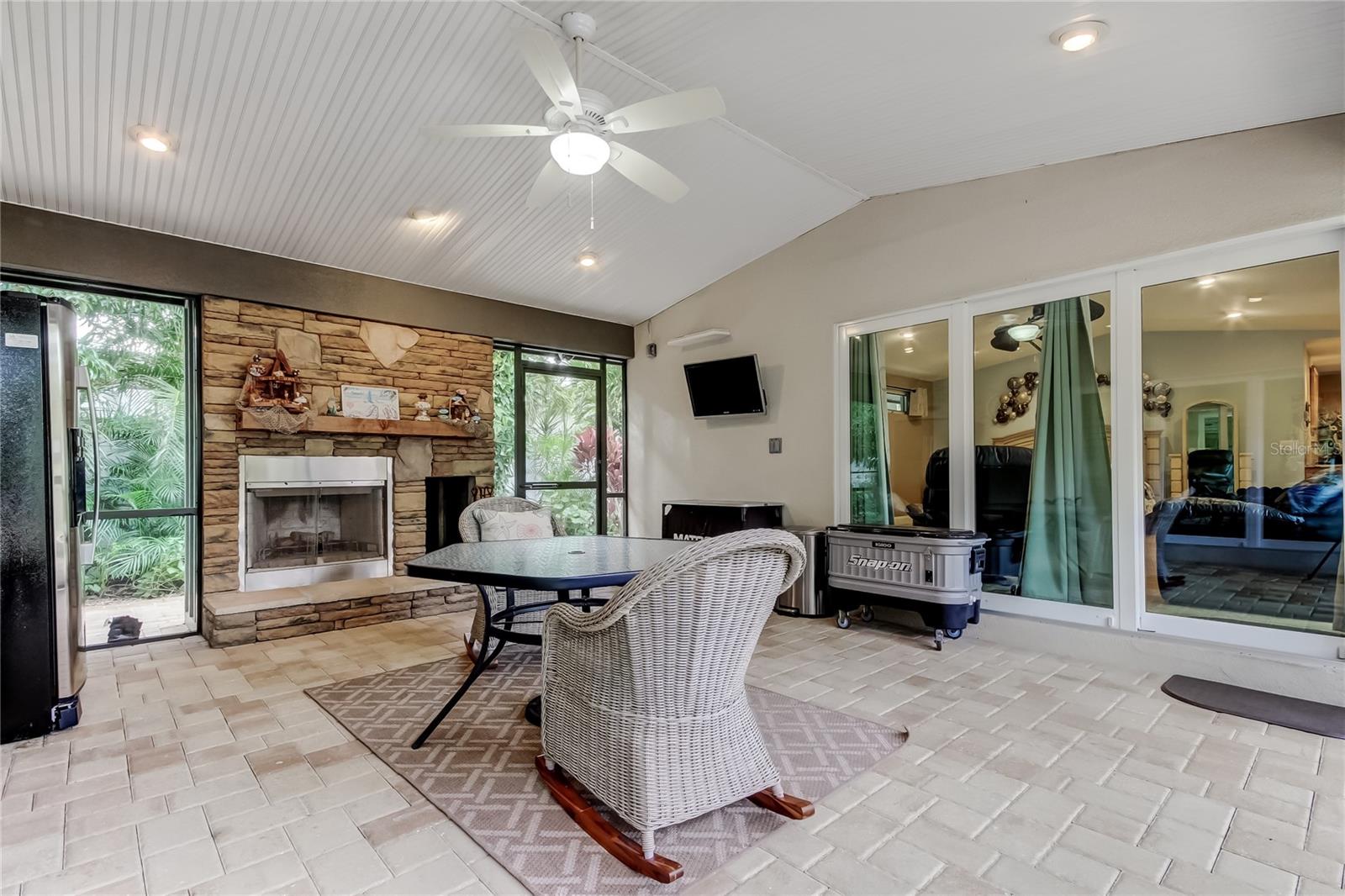 The ultimate Bonus, welcome to the breezeway with a wood burning fireplace. I'm calling this room football heaven.