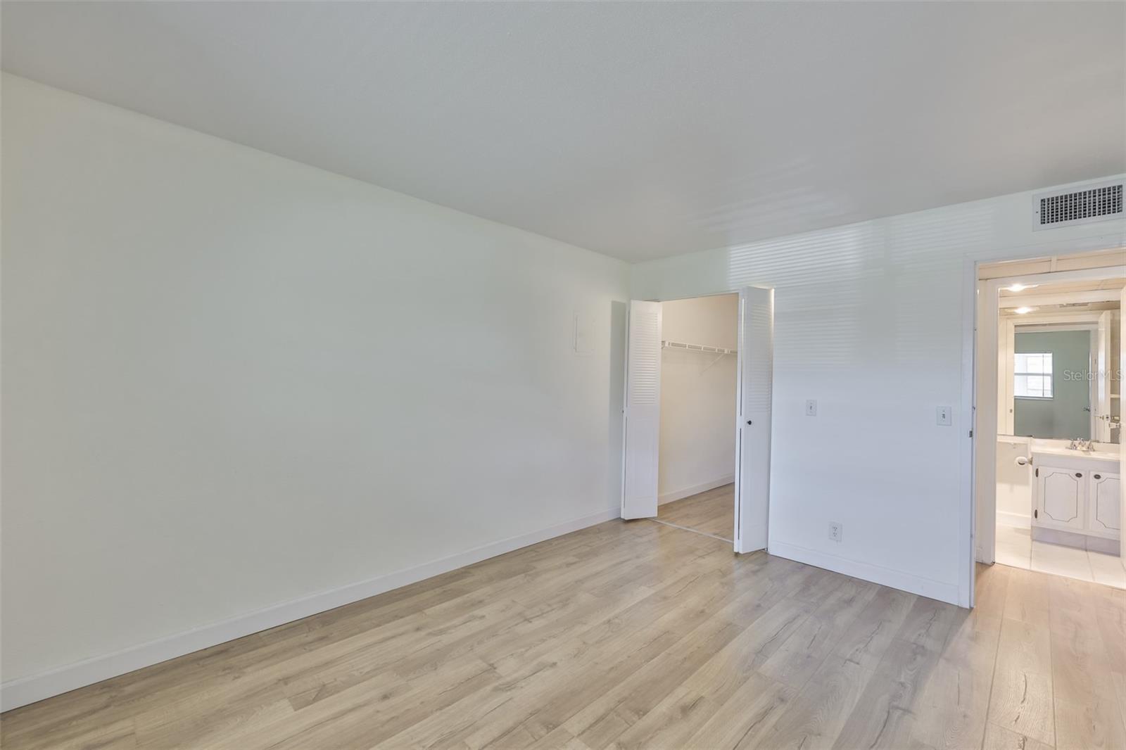 Primary bedroom, walk-in closet left, primary bath right and hallway