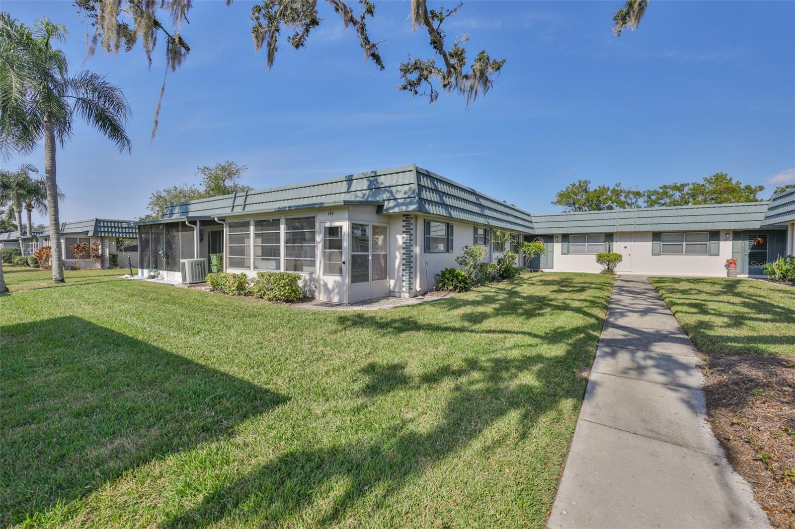Florida Room and rear door, golf cart doors - just steps from the covered carport