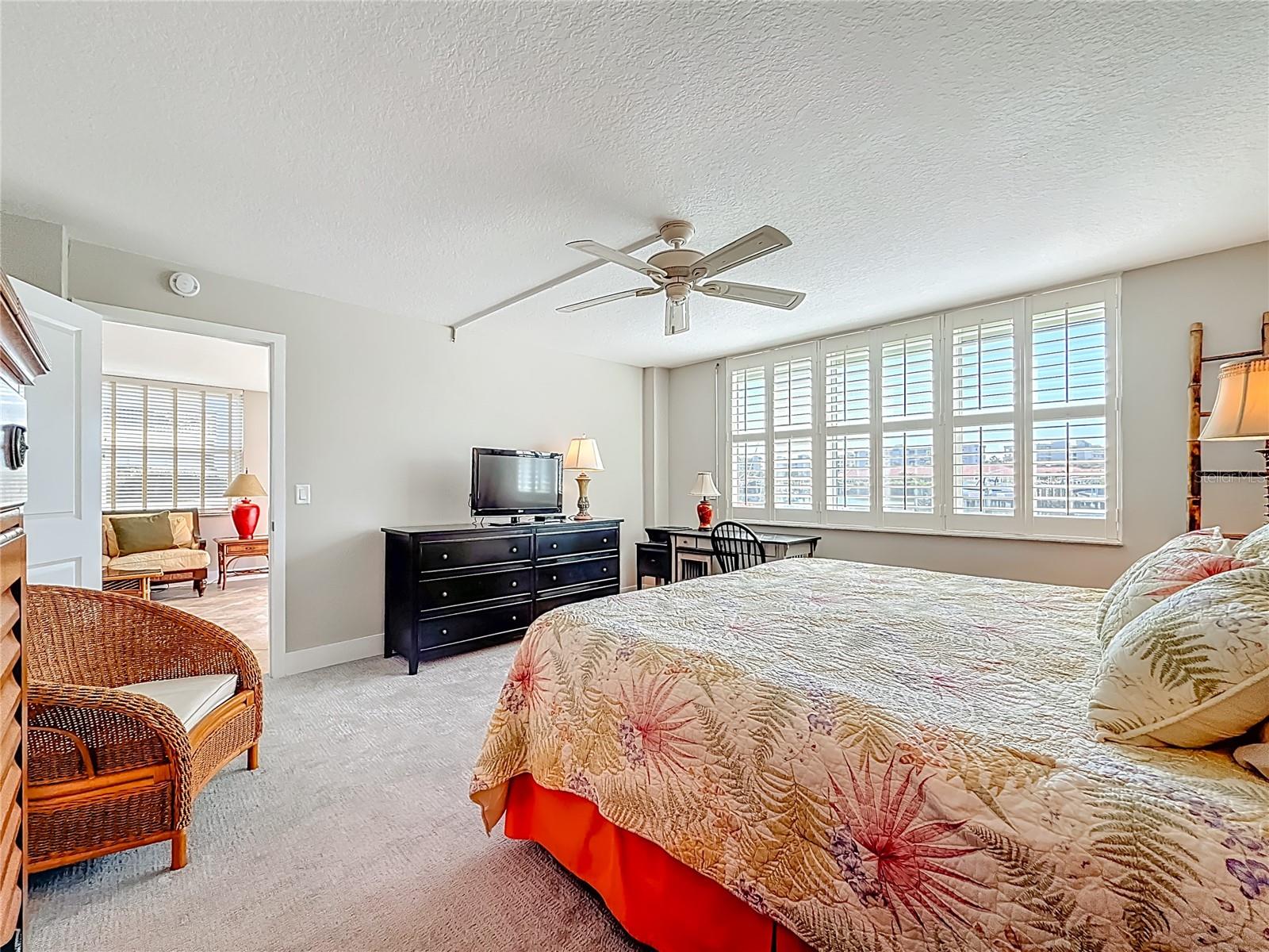 This view shows that the primary bedroom is just off the living space on the waterside of the condo