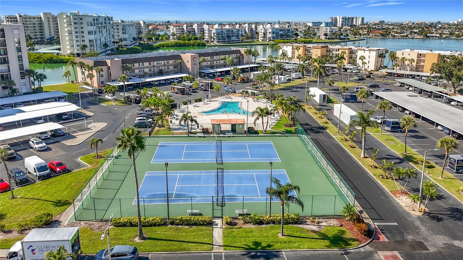 Aerial view of the tennis and pickleball courts and the Y shaped pool that is right across from the Enterprise building where this unit is located.