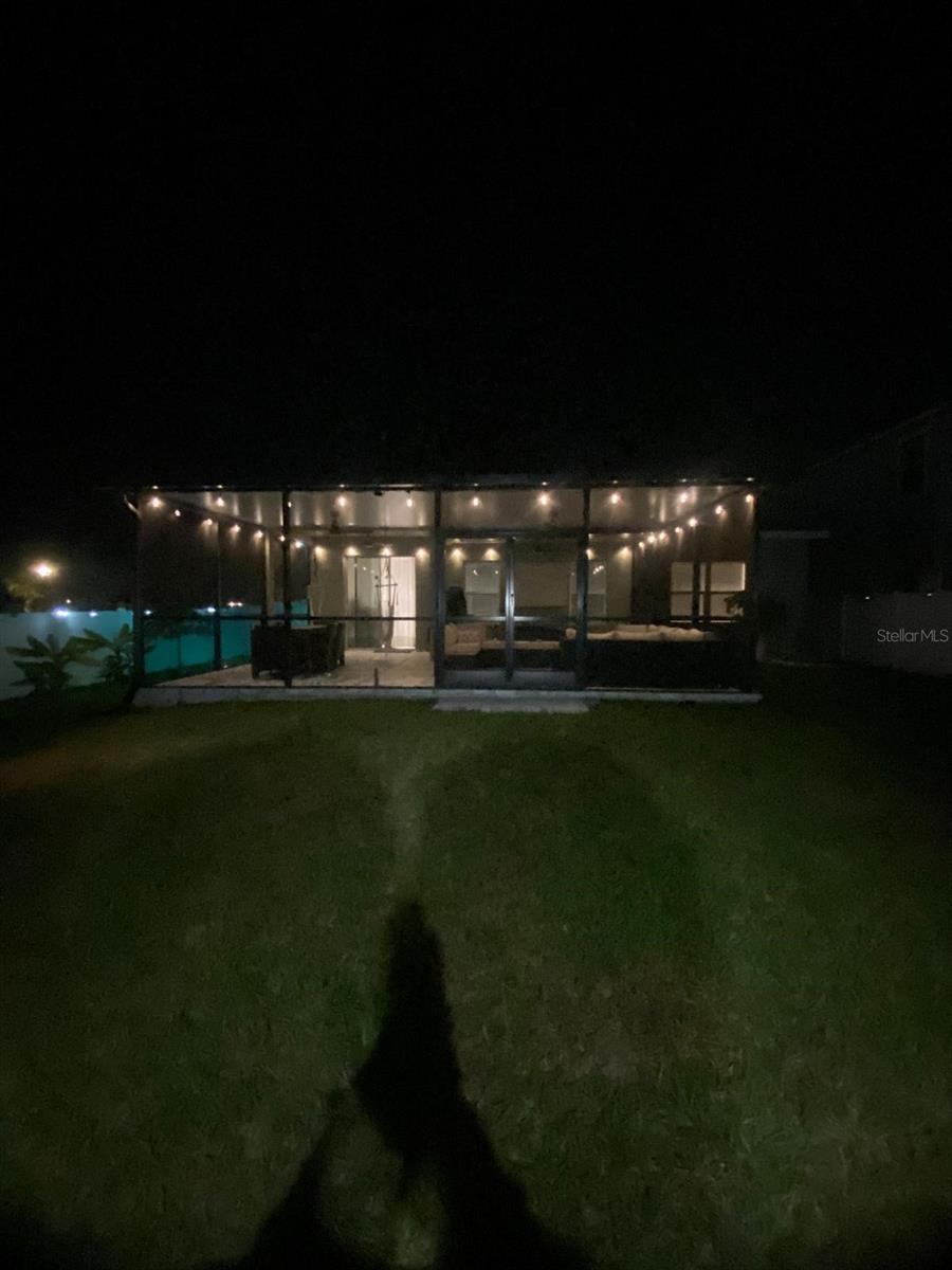 View of the back porch at night with all the ambient lights