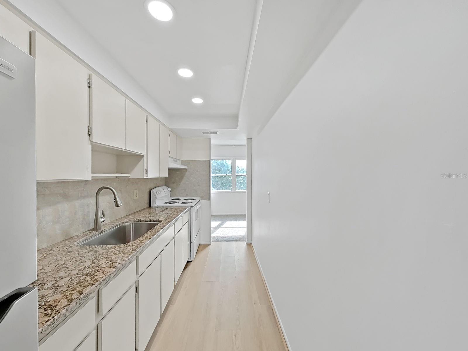 The galley kitchen opens to a ‘Florida Room’ !