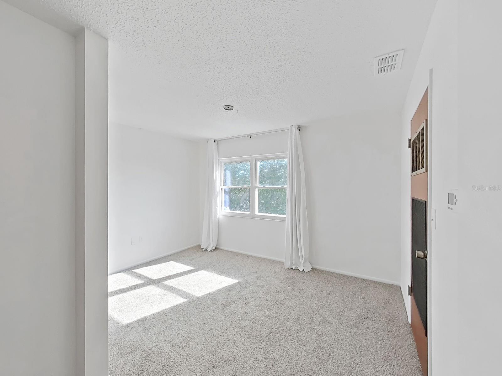 Versatile Florida Room is ideal for a home office, hobby space, or additional lounge area.