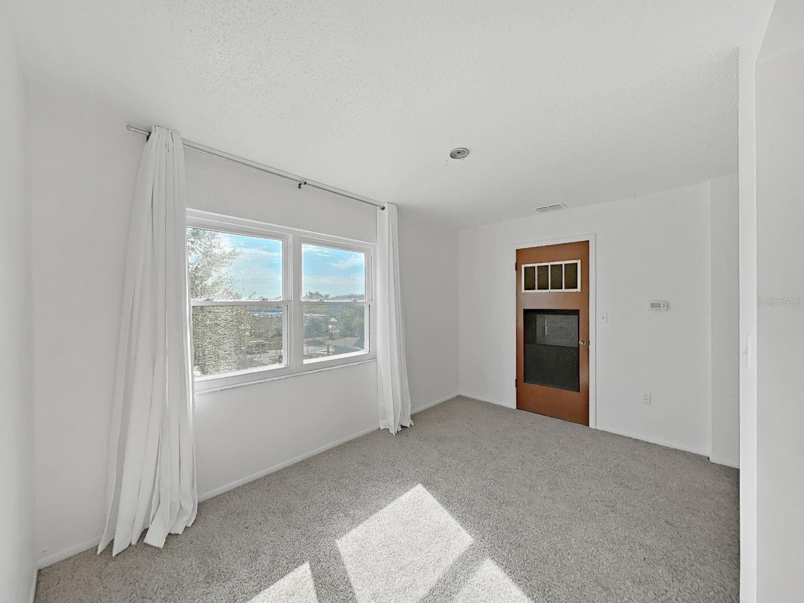 The Florida Room is brightly lit with natural light and more storage with the utility closet!