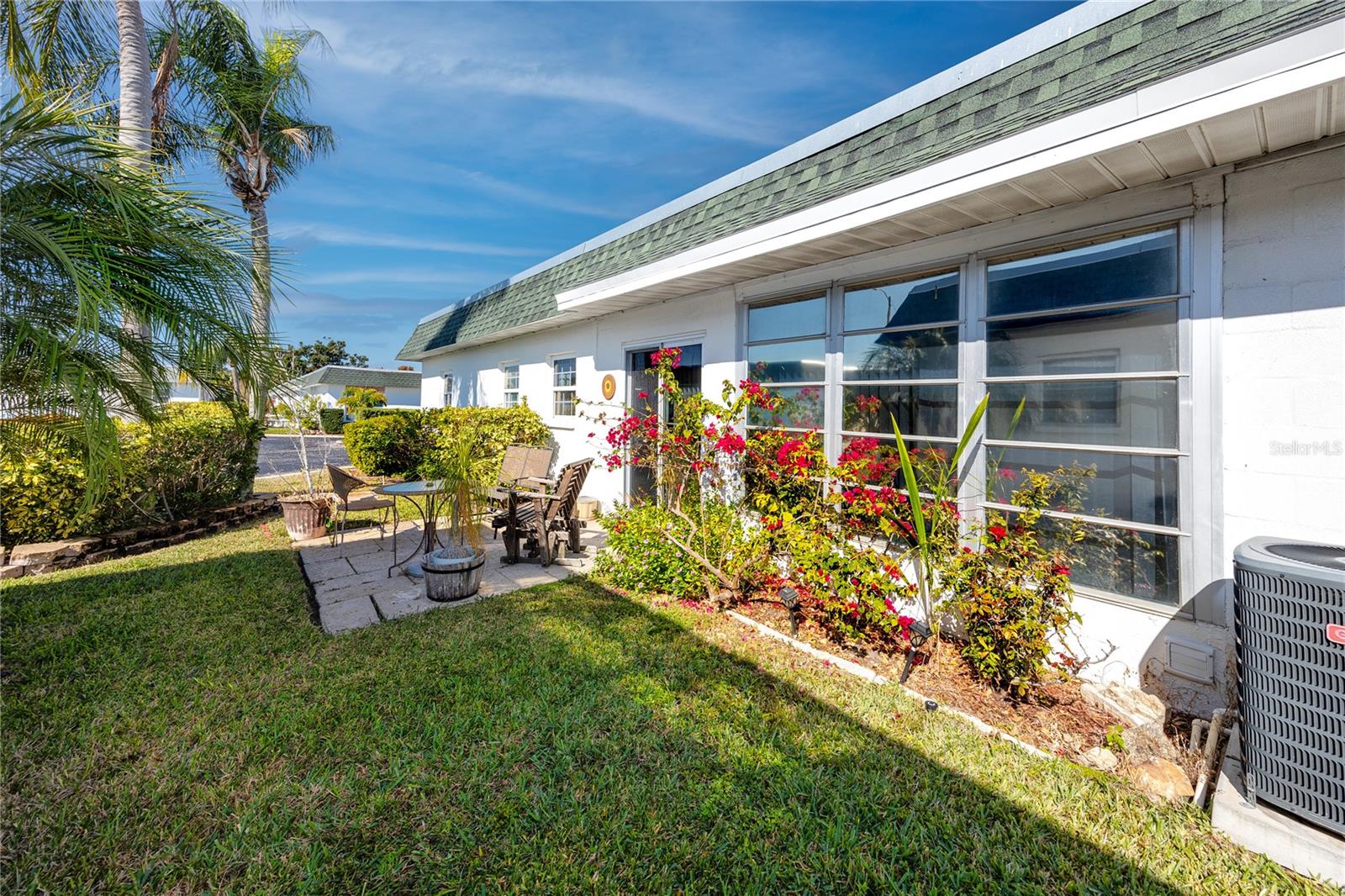 View at back of unit. Mature landscaping and patio.