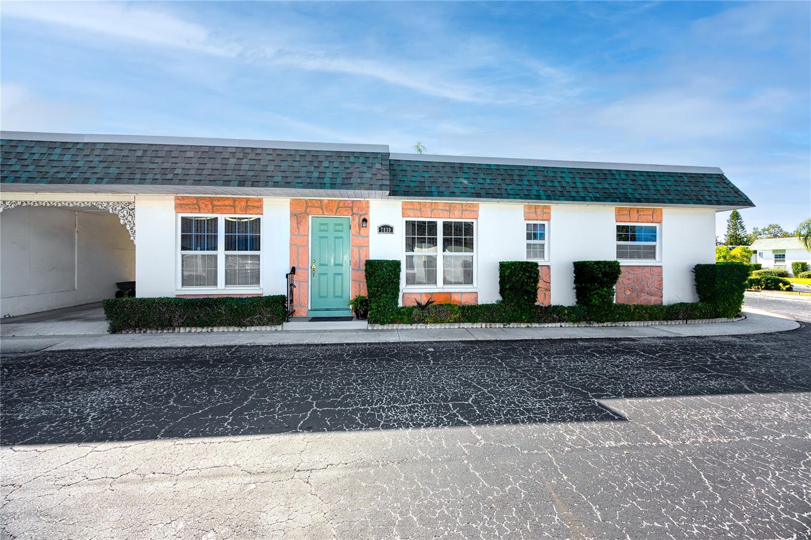 Front view showing end unit with covered carport.