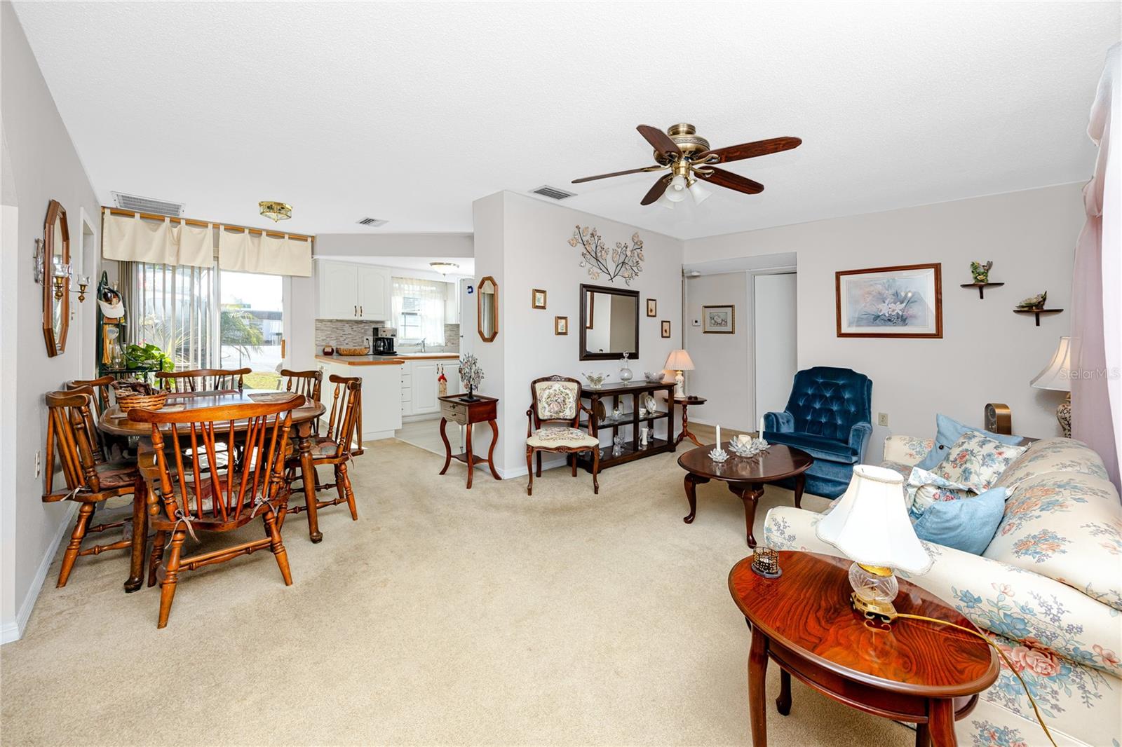 View from inside front door into Living Room, Dining area and Kitchen.