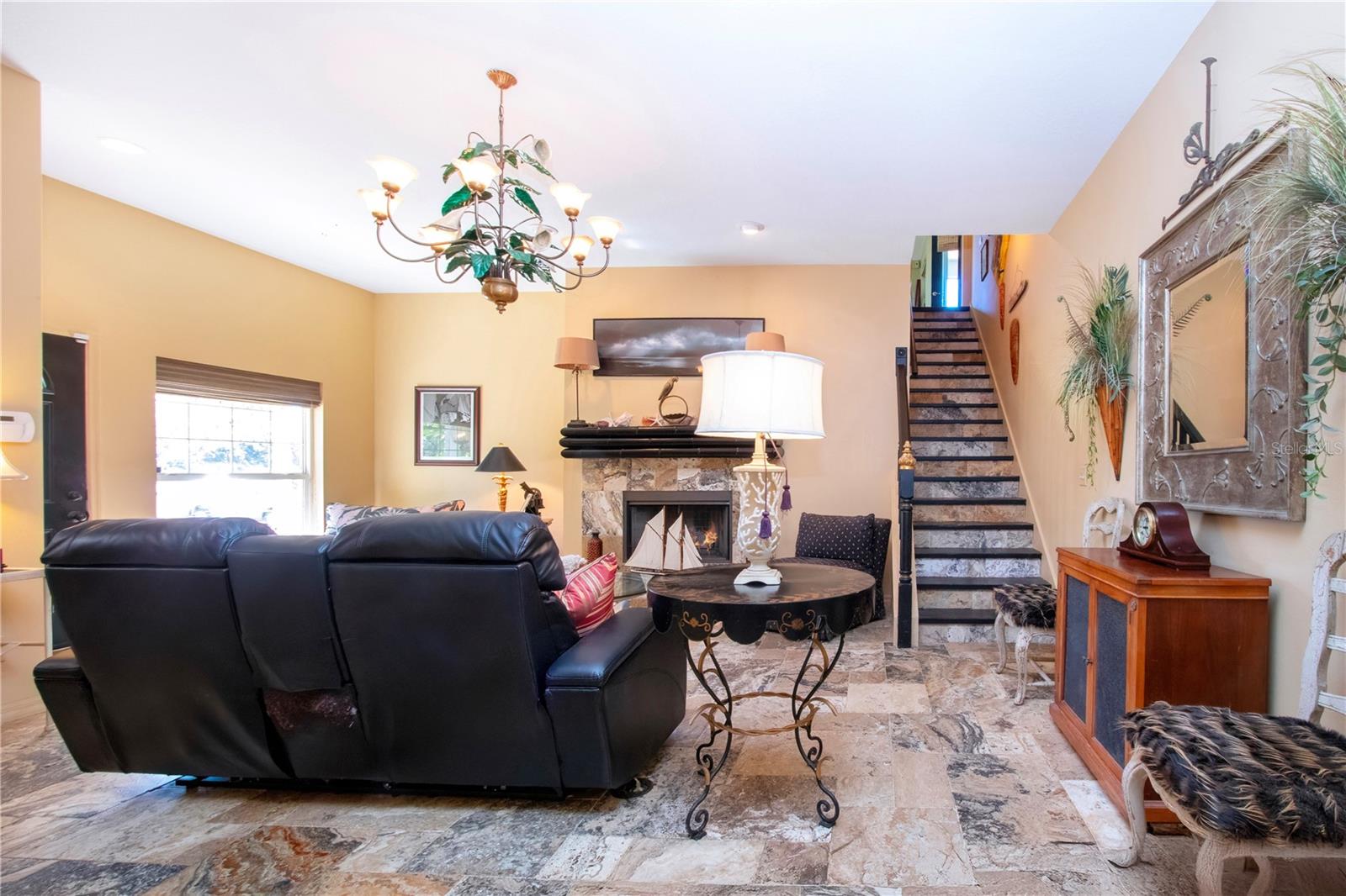 Living room with a view of the stairs that goes up to the 3rd bedroom