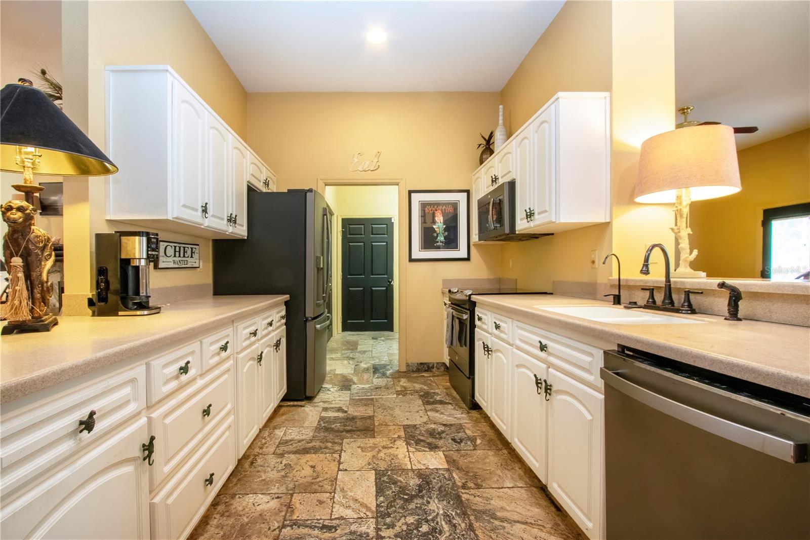 this kitchen open up on each side for a view of the both living room and great room