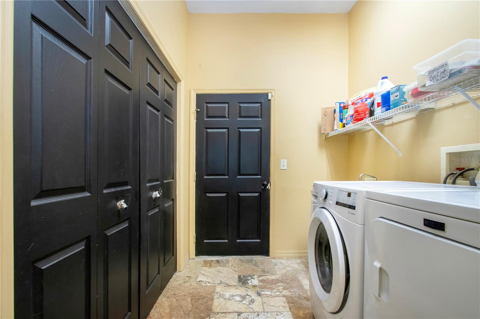 Laundry room with a double closet for extra storage