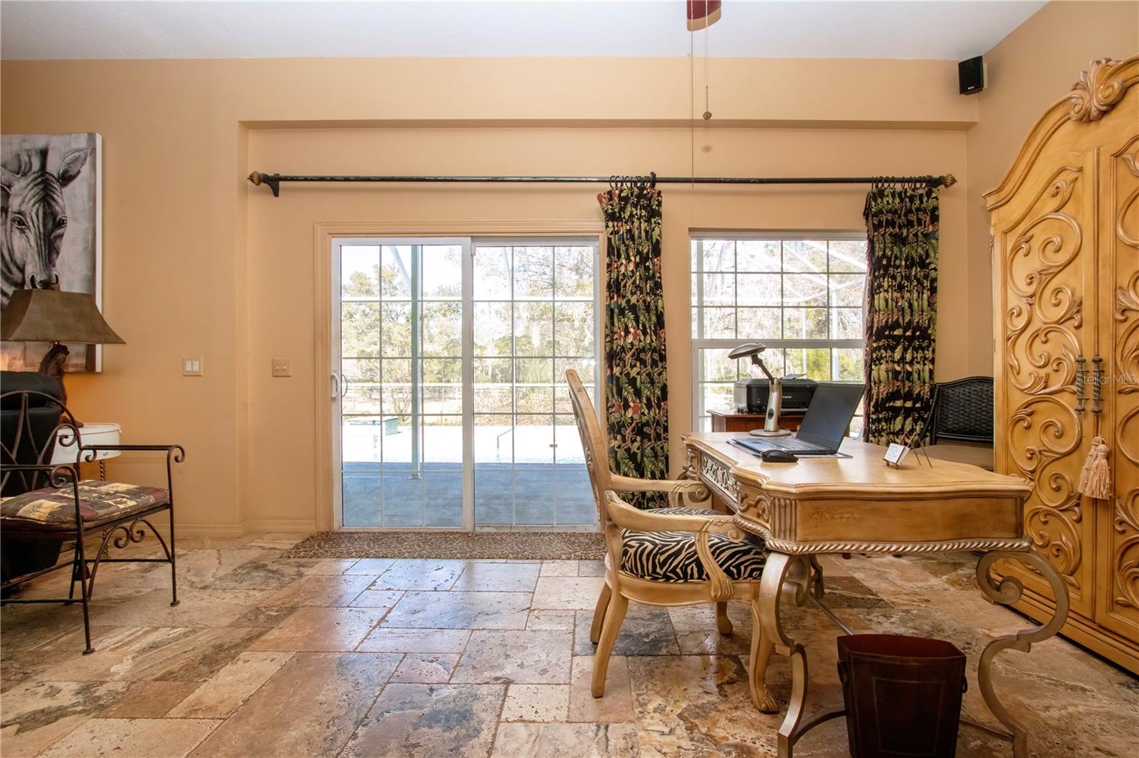 View of the pool from the kitchen with an office or could be dining area