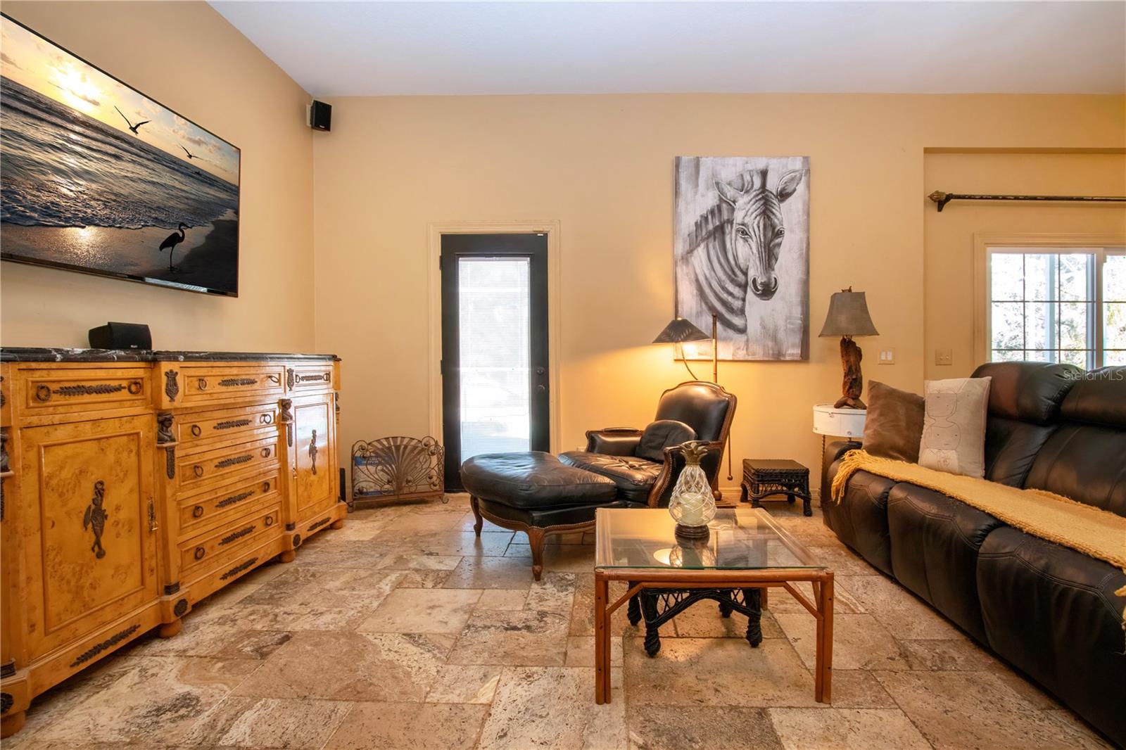 great room with a door leading to the pool