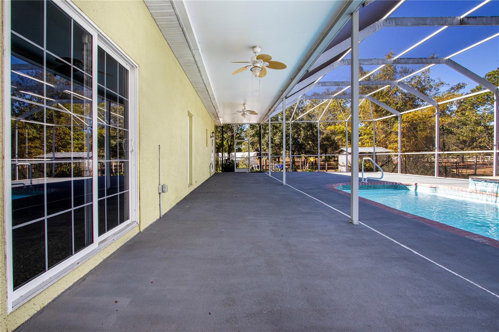 the pool deck to the sliding lass doors into house