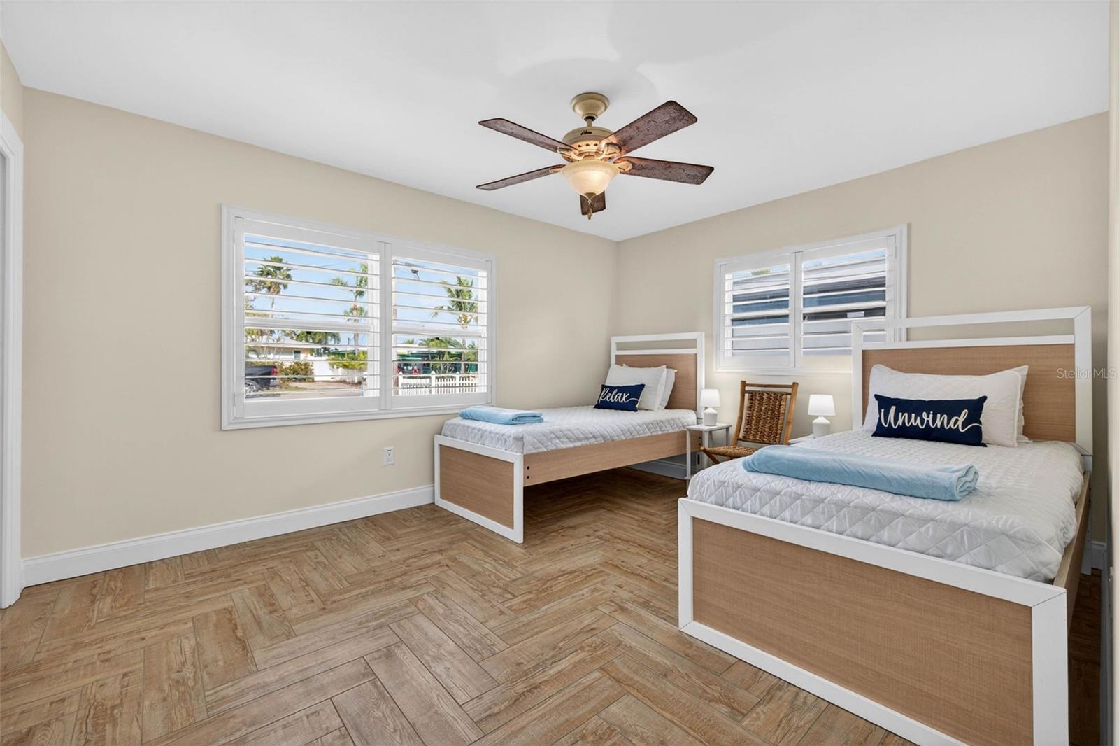 2 beds  with herringbone wood-look tile, plantation shutters and an en-suite bathroom