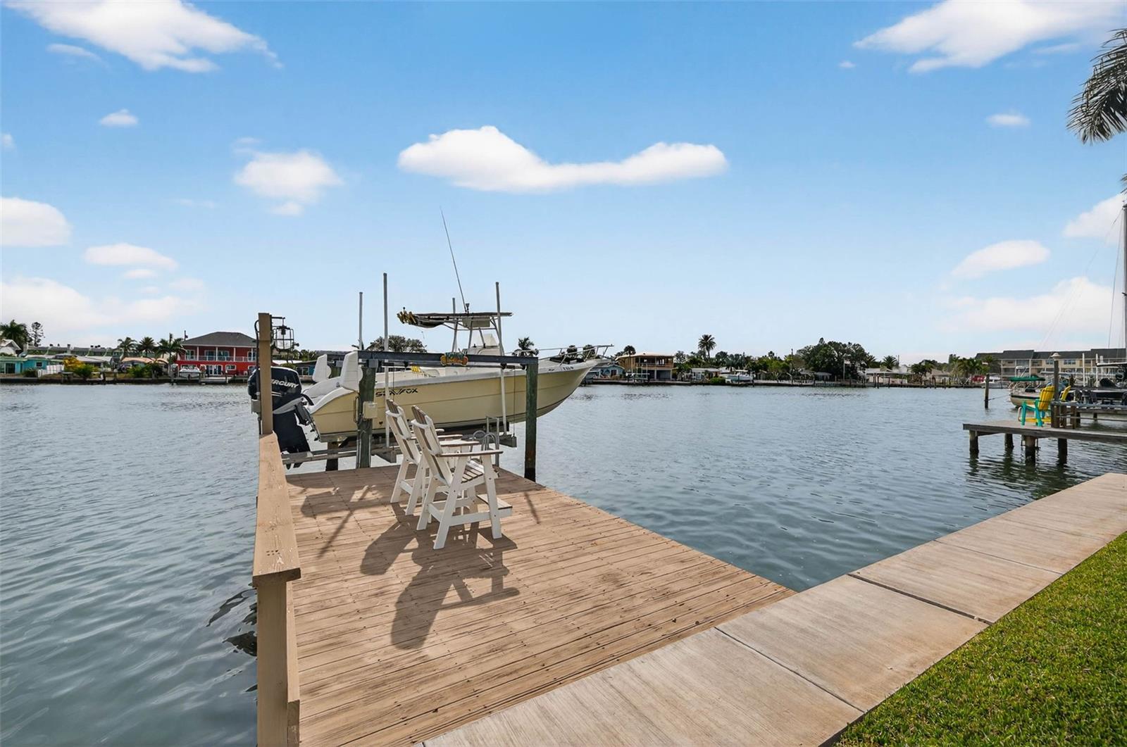 7,000 lb boat lift and recently resurfaced wood dock