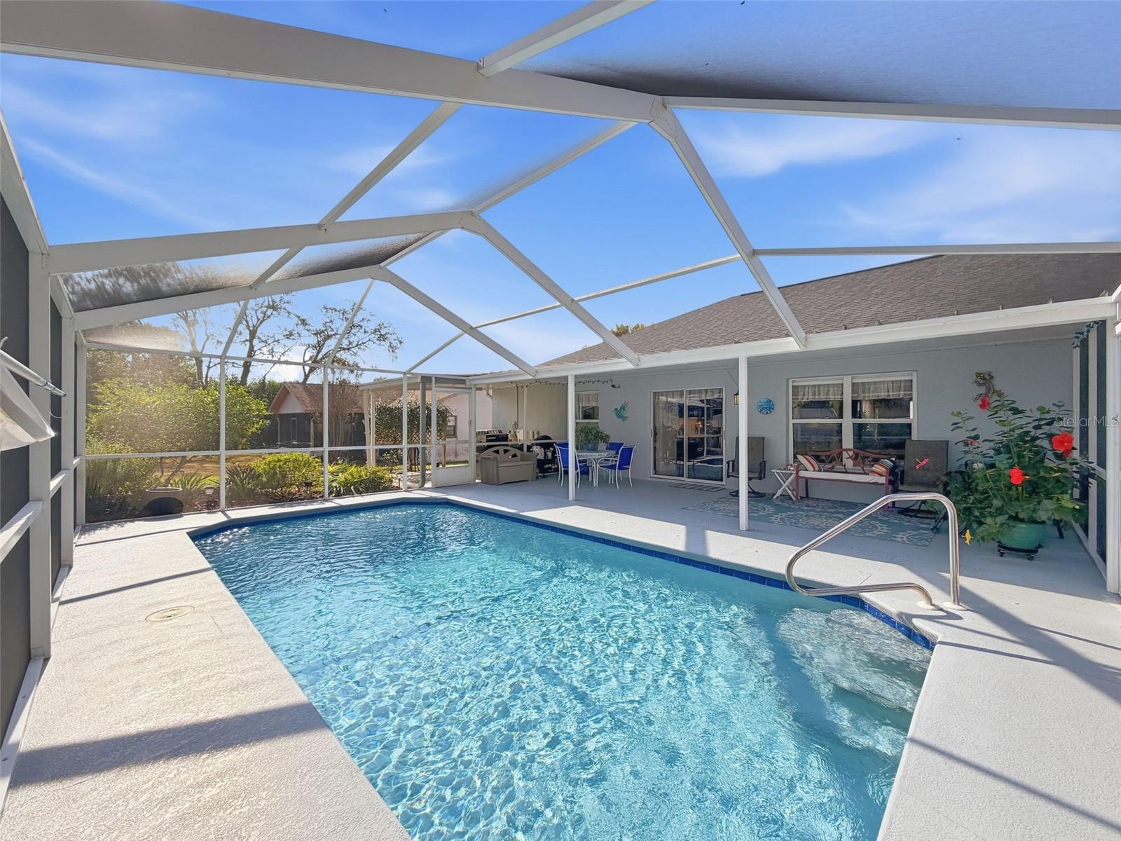 Gorgeous sparkling pool with large covered lanai