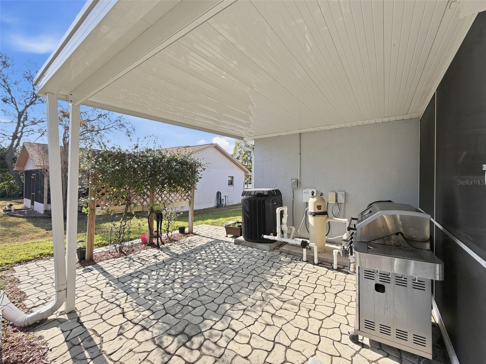 Cobblestone paved covered area just outside the pool! Perfect for your barbeques