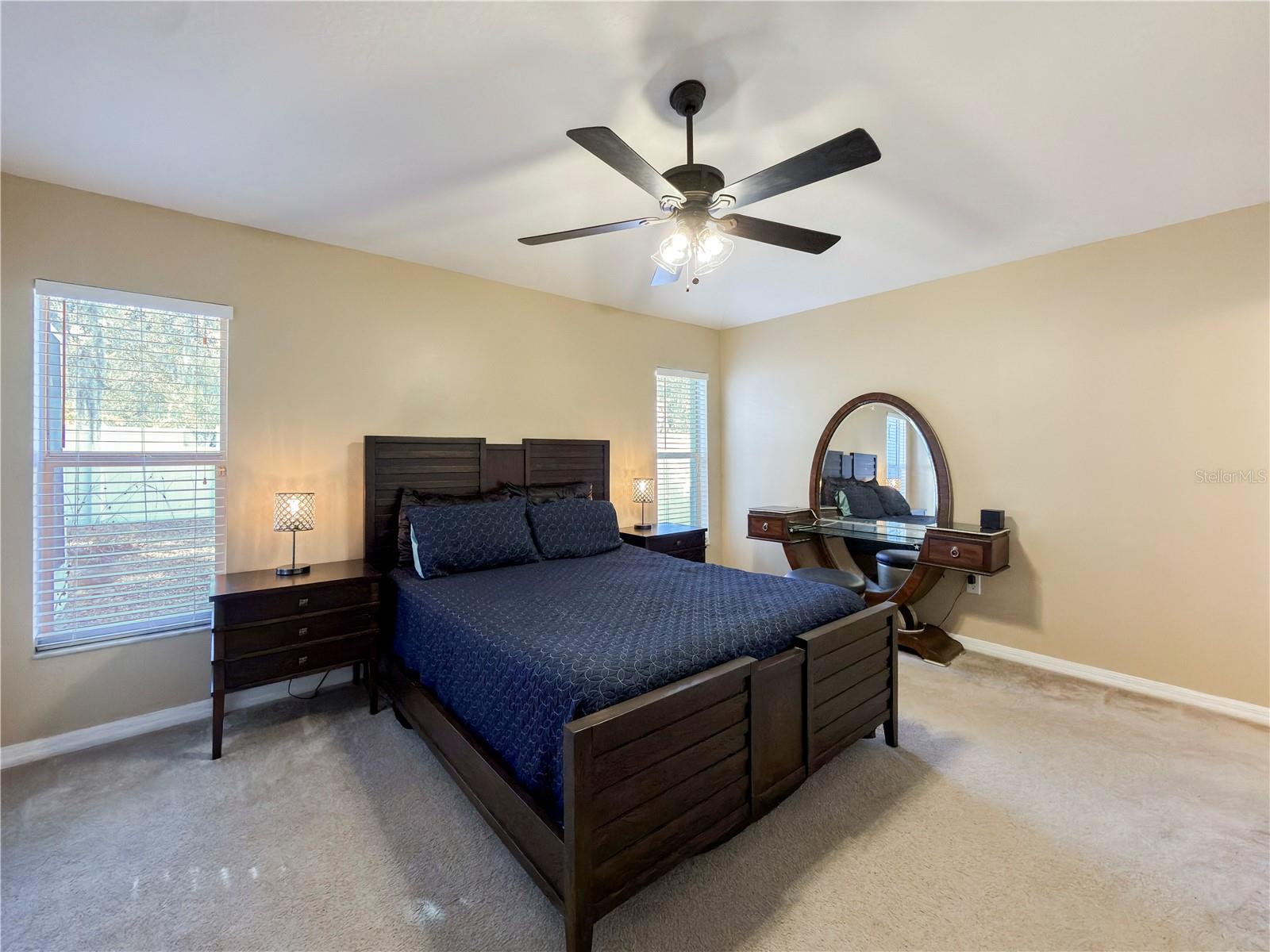 Spacious primary suite in the rear of the home which overlooks the wooded back yard and conservation