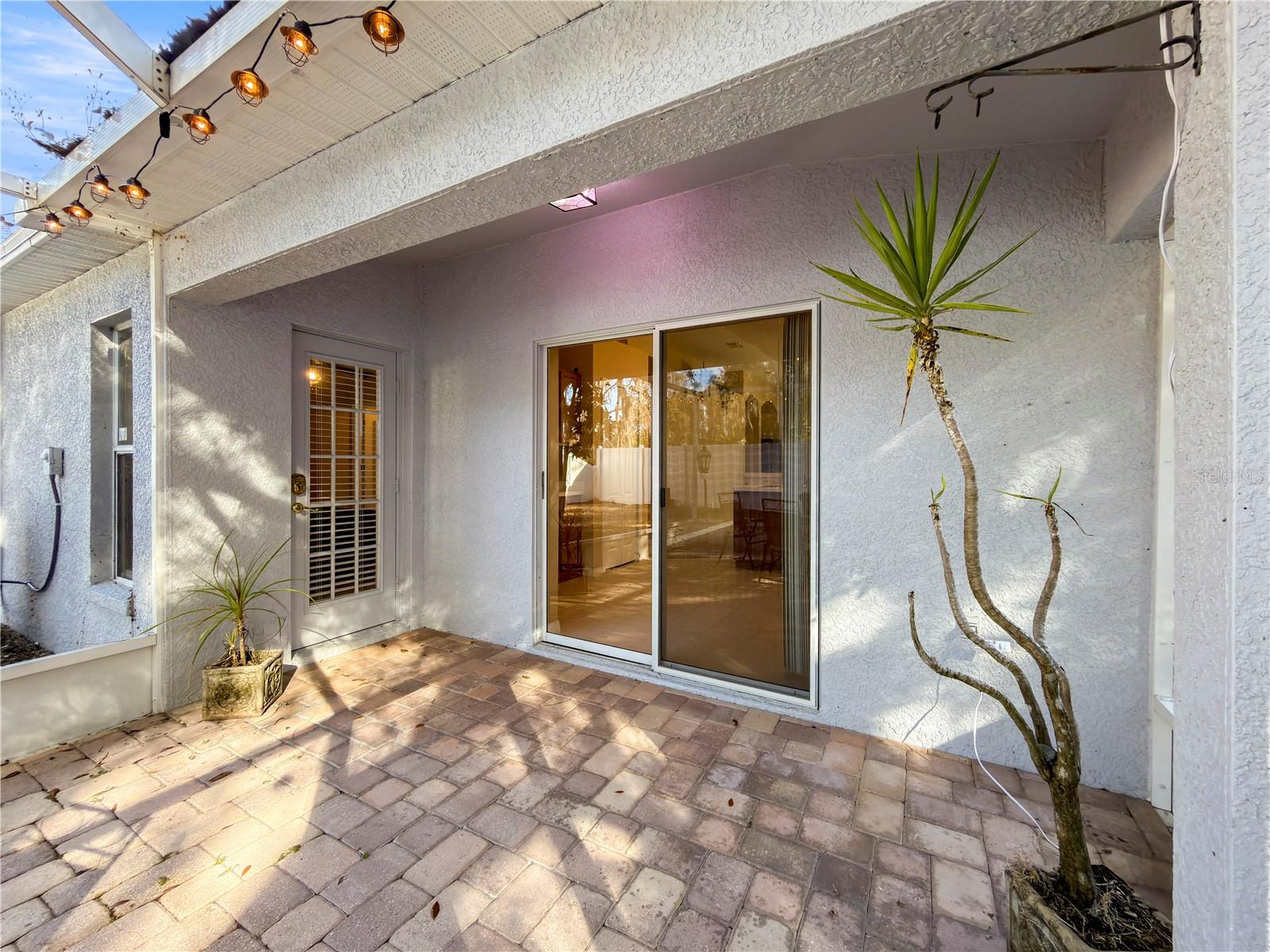 Covered back patio with access to the kitchen via sliding door and access to the primary suite via private door