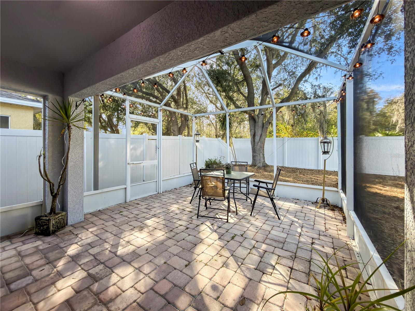 Covered patio expands into a large screened-in lanai, perfect for entertaining