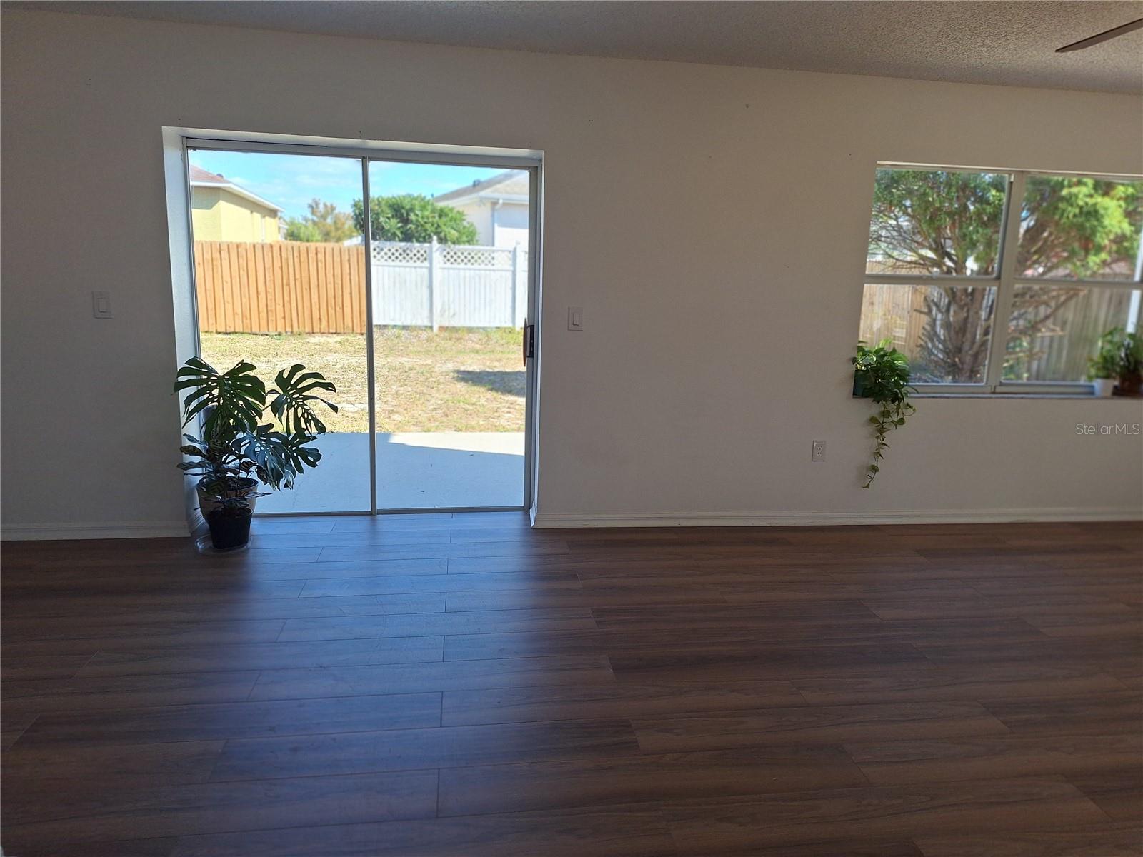 Sliders open to a large Backyard and Patio