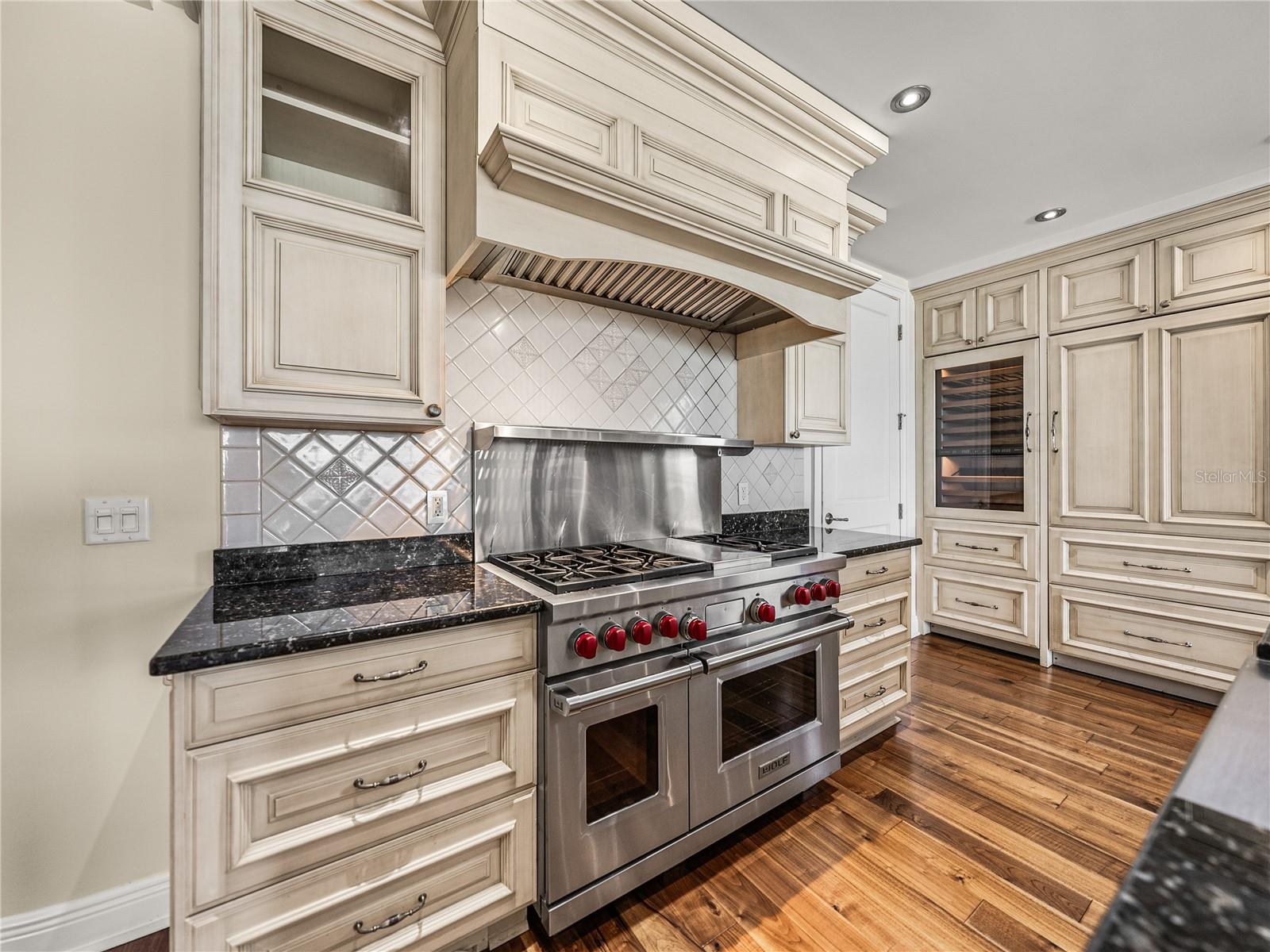 A dual-fuel Wolfe range with natural gas burners and electric dual ovens.