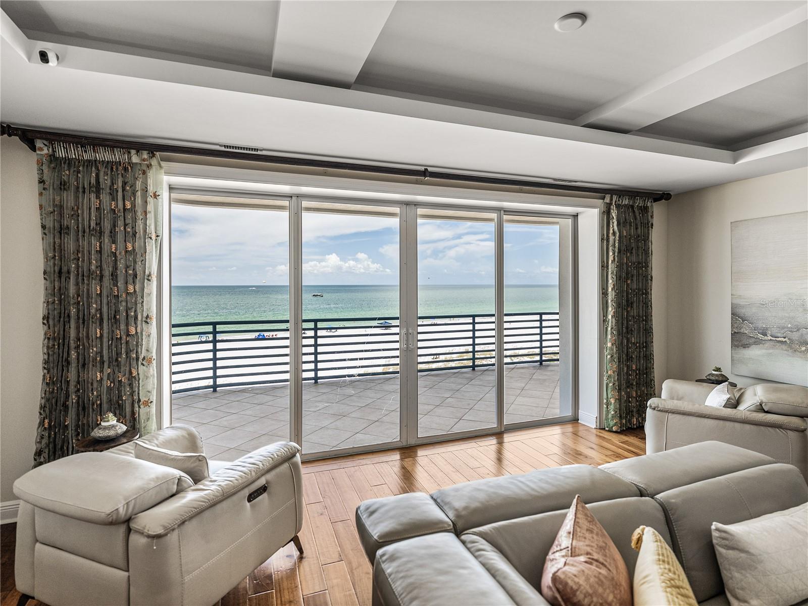 The warm gulf waters lap the edges of the pristine white sand. Since this photo was taken, new slider were added here and in the primary bedroom at a cost of $36K.