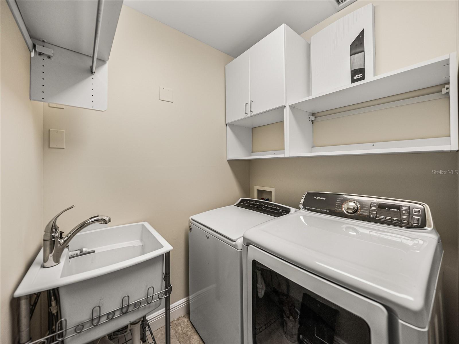 The laundry room has a gas dryer.  Behind the louvers doors is the HVAC unit for the east end of the unit and the hot water heater.