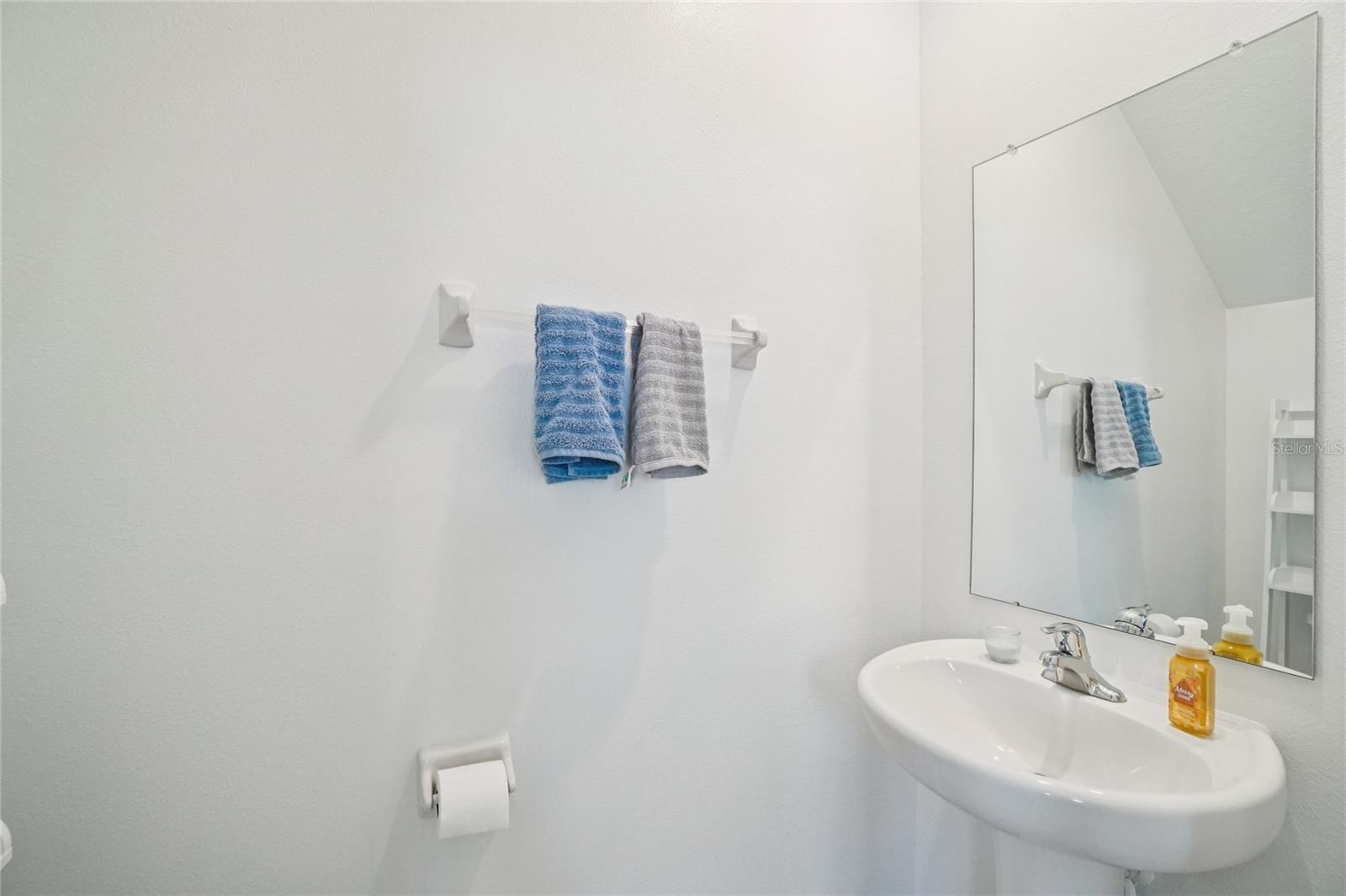 Half Bathroom – Convenient first-floor half bath with a pedestal sink and neutral finishes.