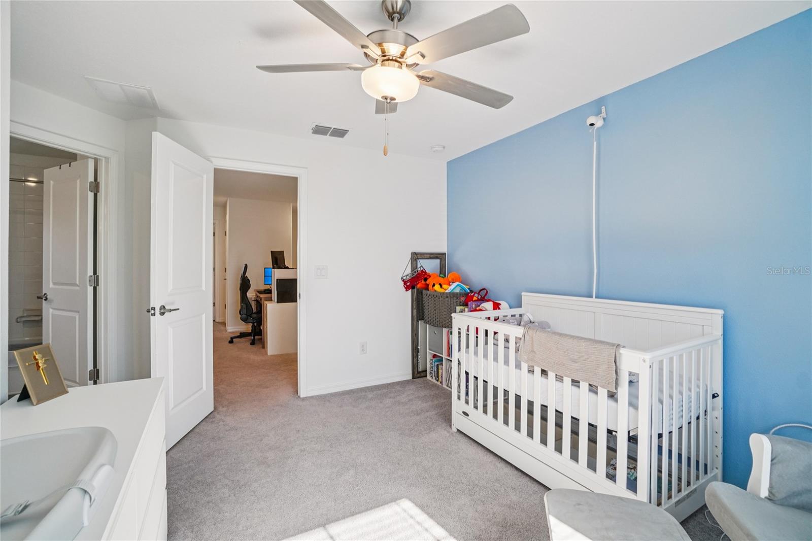Bedroom 2 – Angle 2 – Additional view of the bedroom showing ample floor space and easy access to the hallway and bathroom.