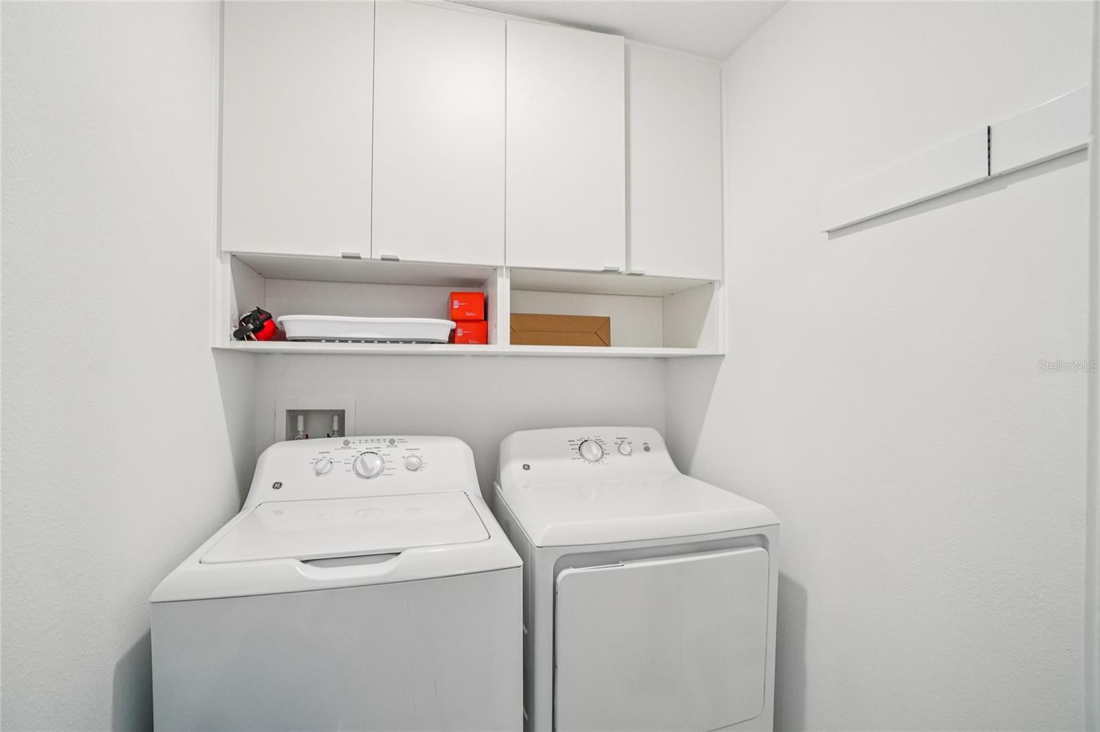Laundry Room – Convenient upstairs laundry area with full-size washer and dryer and overhead cabinetry for extra storage.