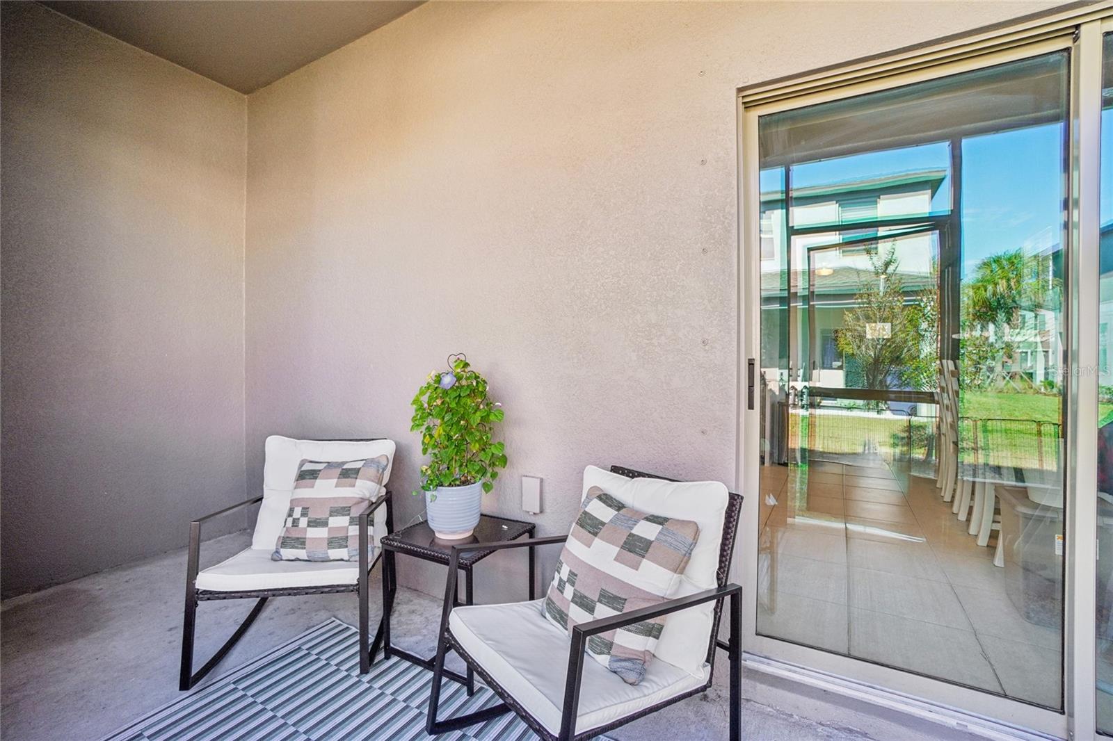 Rear Lanai - Open patio space with room for outdoor seating, offering a comfortable spot to relax with views of the backyard.