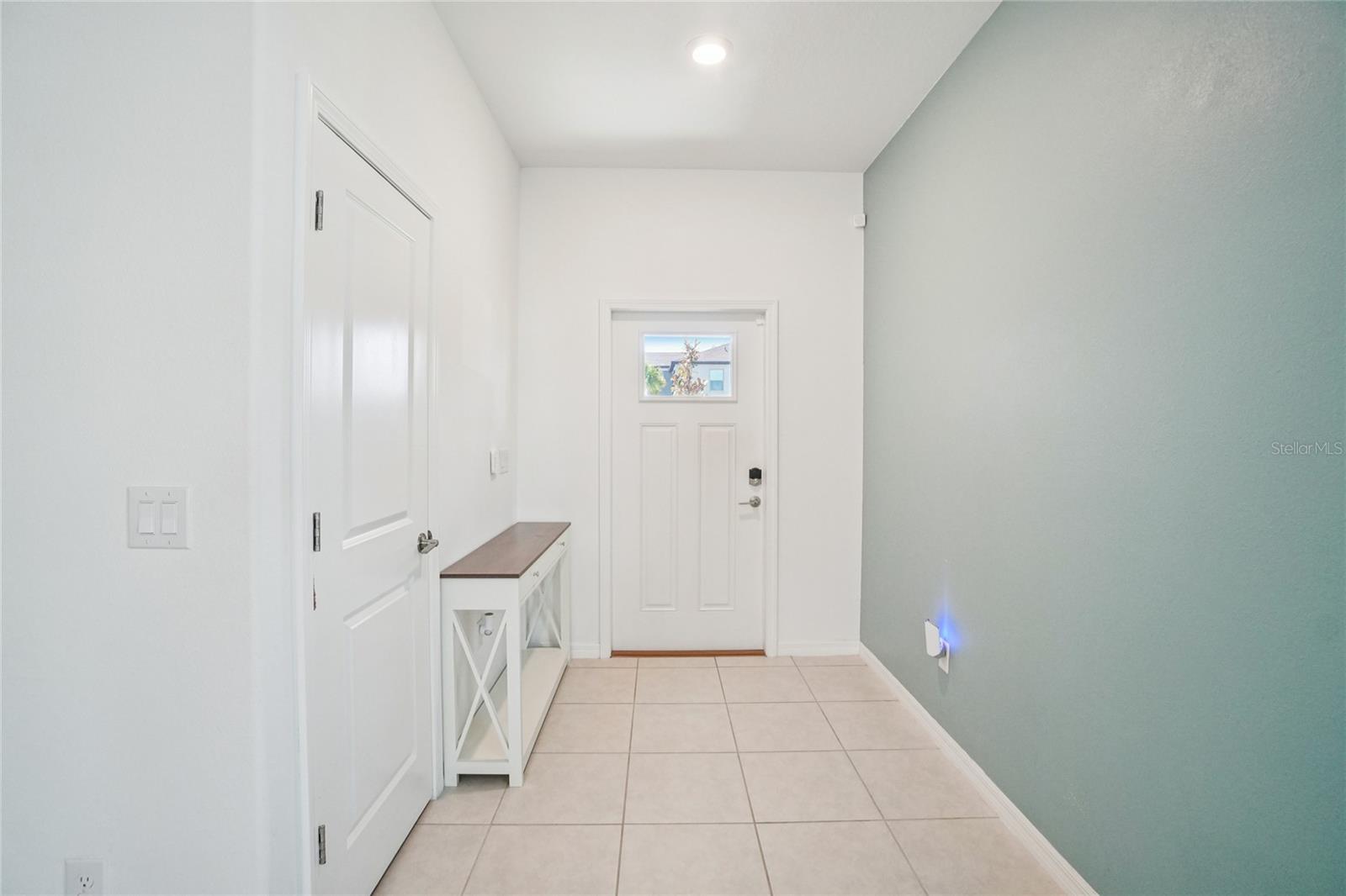 Foyer – Bright foyer with tile flooring, high ceilings, and a clean, modern aesthetic that sets the tone for the home’s interior.